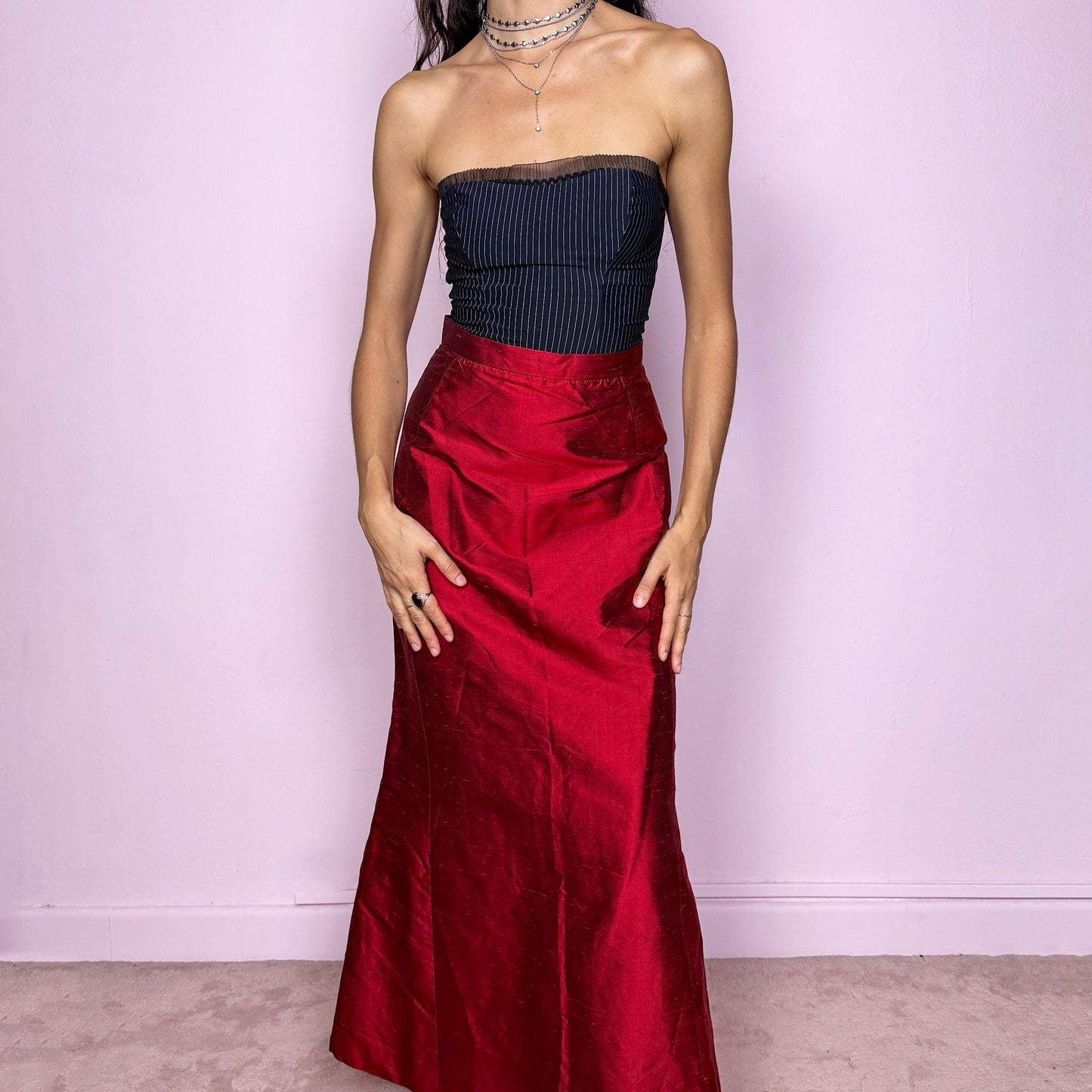 This vintage 90s red shiny maxi skirt features a sculpted mermaid silhouette with a high-waisted fit and back zipper closure. Made in France from non-stretch polyester, it radiates diva allure with a formal, romantic tone, perfect for gala nights, prom, or elegant evening events. A stunning statement piece of timeless sophistication. Made from non-stretch polyester. Great vintage condition.