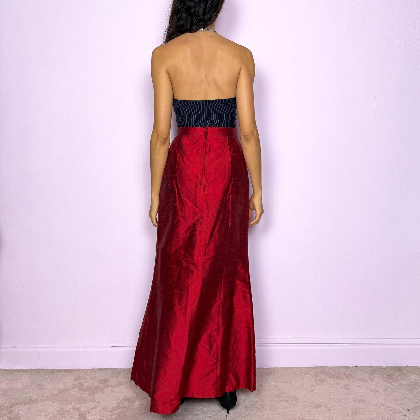 This vintage 90s red shiny maxi skirt features a sculpted mermaid silhouette with a high-waisted fit and back zipper closure. Made in France from non-stretch polyester, it radiates diva allure with a formal, romantic tone, perfect for gala nights, prom, or elegant evening events. A stunning statement piece of timeless sophistication. Made from non-stretch polyester. Great vintage condition.