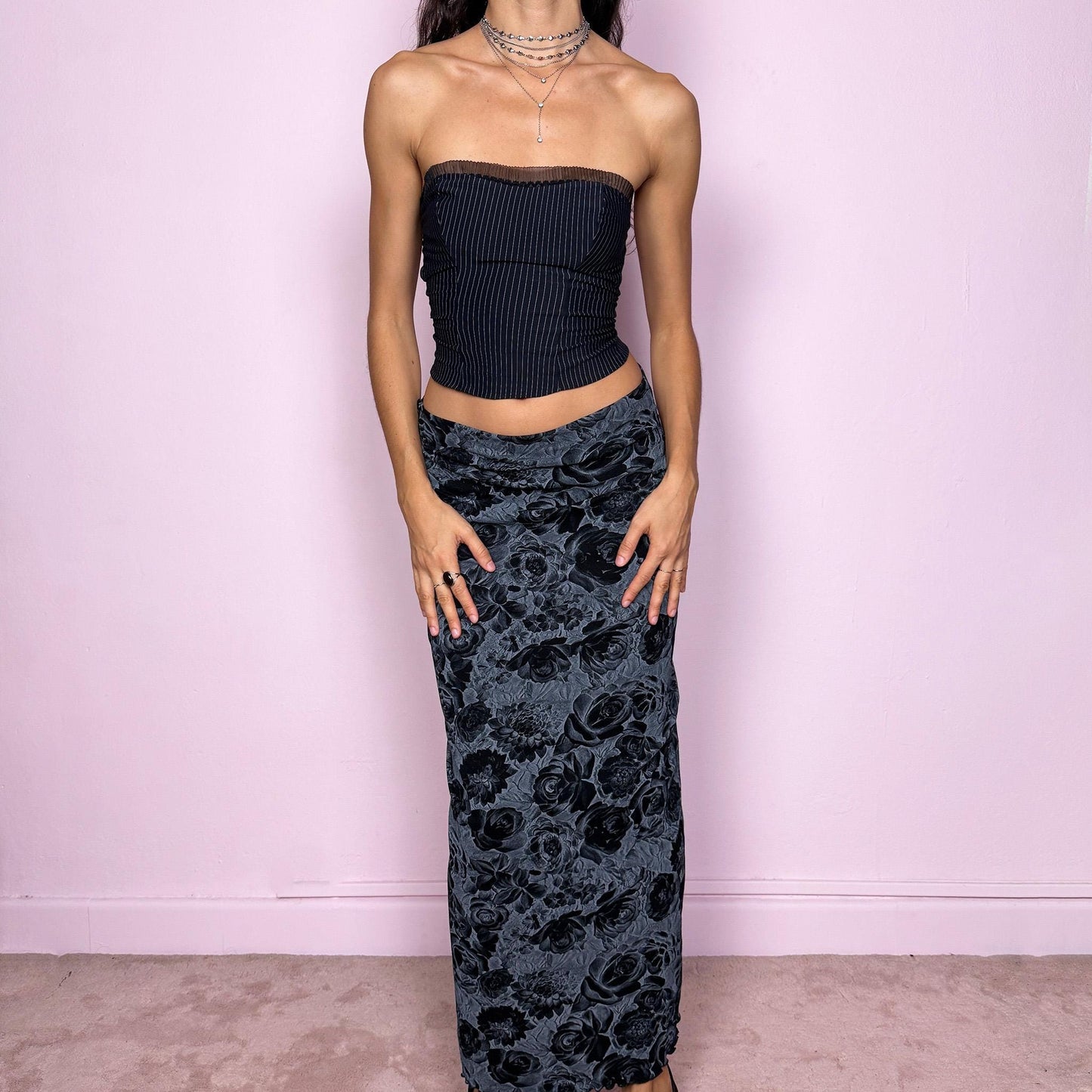 This vintage 2000s black and gray floral rose print midi skirt features a soft elastic waist and a slightly body-hugging silhouette. Made in Europe from a polyamide blend, it channels whimsigoth and 90s grunge-inspired elegance, perfect for everyday wear or dark romantic styling. Fits mid- to low-rise for size S. Excellent vintage condition.