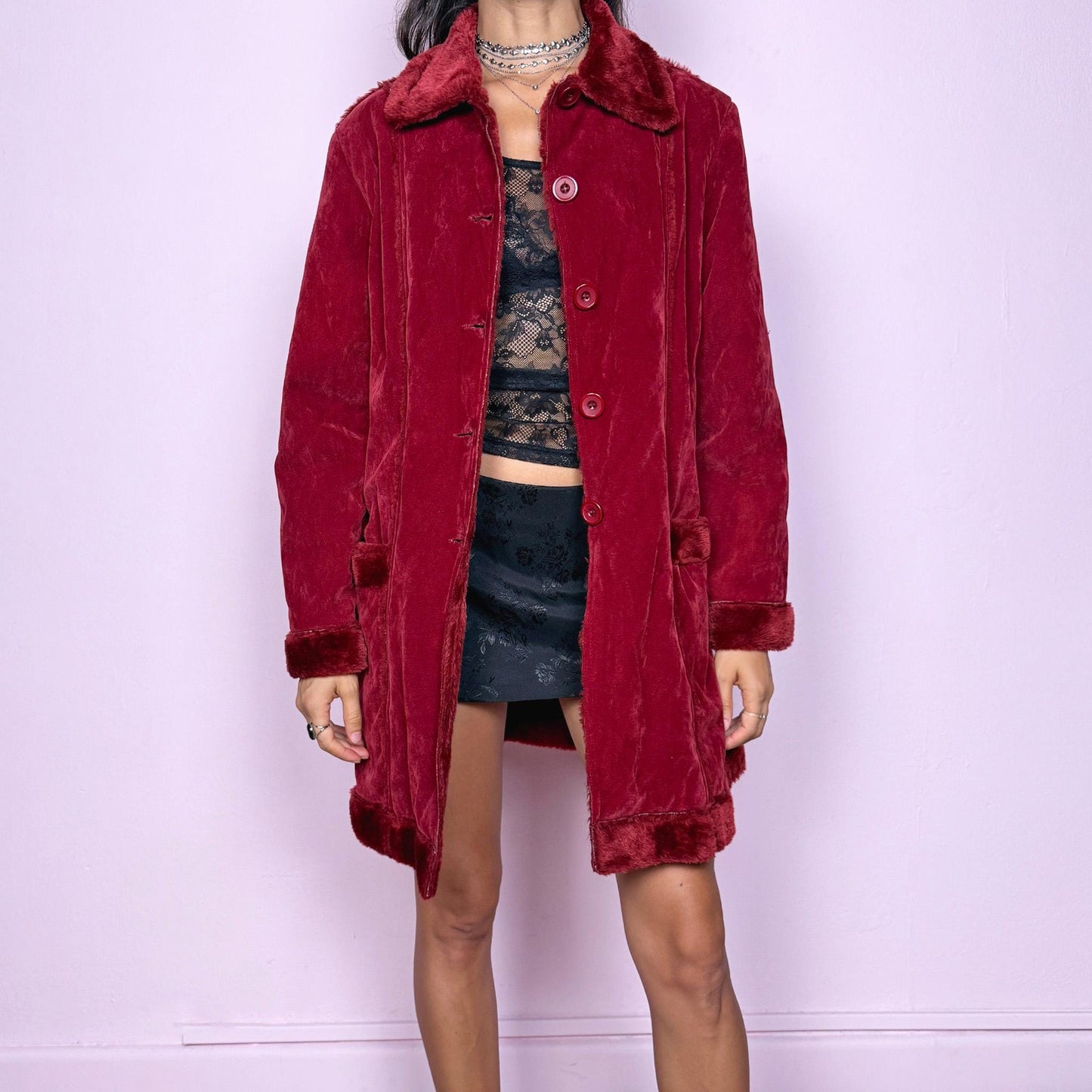 This vintage 2000s red faux suede coat features a plush faux fur lining, collar, and cuffs inspired by the iconic Penny Lane silhouette. Designed with front pockets and button closure, it captures whimsical Y2K winter charm with a boho-grunge edge, perfect for festivals or statement cold-weather styling. Made from polyester faux suede and faux fur. Great vintage condition.