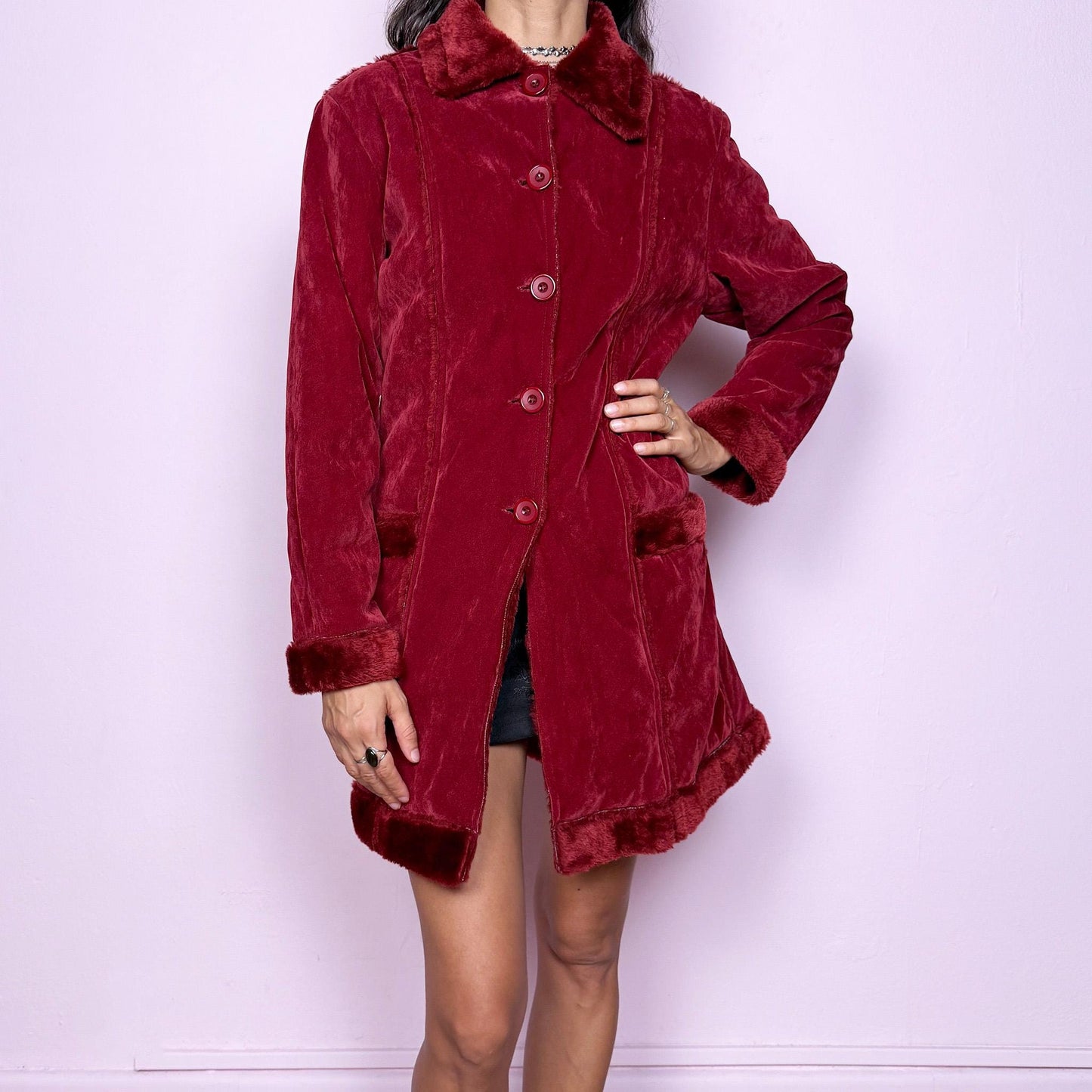 This vintage 2000s red faux suede coat features a plush faux fur lining, collar, and cuffs inspired by the iconic Penny Lane silhouette. Designed with front pockets and button closure, it captures whimsical Y2K winter charm with a boho-grunge edge, perfect for festivals or statement cold-weather styling. Made from polyester faux suede and faux fur. Great vintage condition.