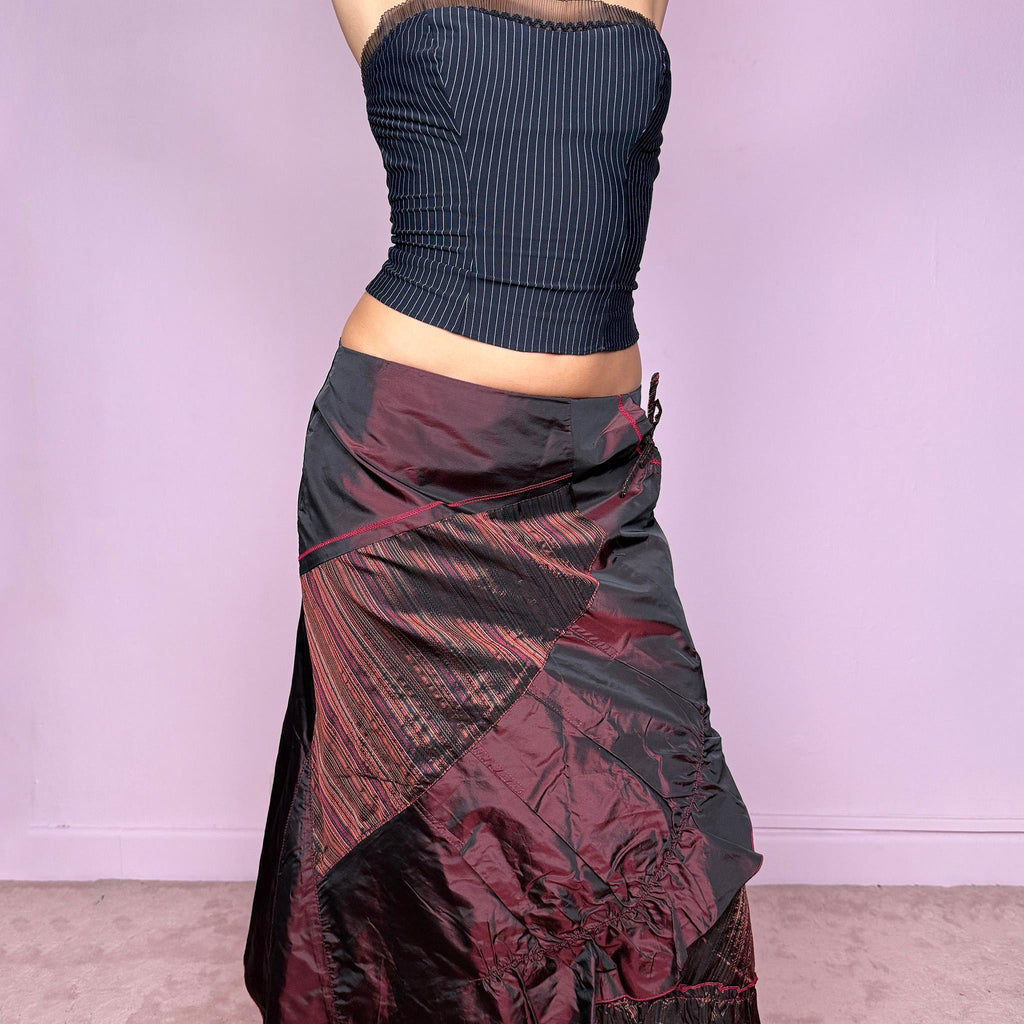 This stunning vintage 2000s maroon-burgundy flared midi skirt features a layered patchwork design with ruched detailing, ruffle hem, and back zipper closure. A whimsical fusion of fairy-grunge and deconstructed Y2K elegance, perfect for autumn nights, creative gatherings, or statement everyday wear. A rare, collectible piece with dark romance allure. It can be worn low to mid rise for size XS/S or high waisted for size M. Made from polyester acetate blend. Excellent vintage condition.