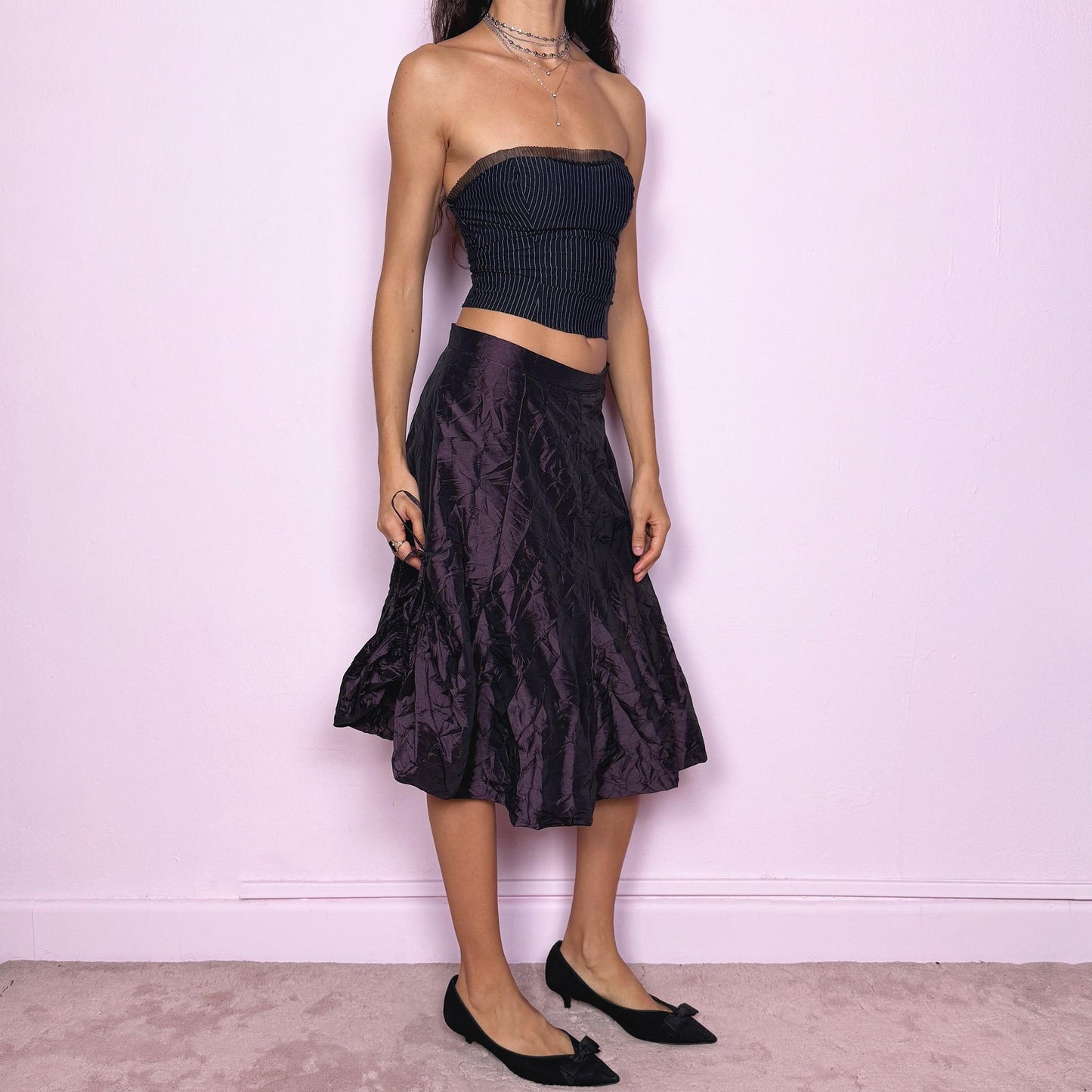This vintage 90s dark purple iridescent midi skirt features a bubble balloon hem and adjustable ruched drawstrings at the sides, allowing for a sculptural, futuristic silhouette. Crafted from textured crinkle fabric with a back zipper closure and no stretch. A rare statement piece merging cyber, dystopian, and techwear aesthetics with Harajuku grunge edge. Can be worn high-waisted for size XL or mid-rise for size L. Excellent vintage condition.