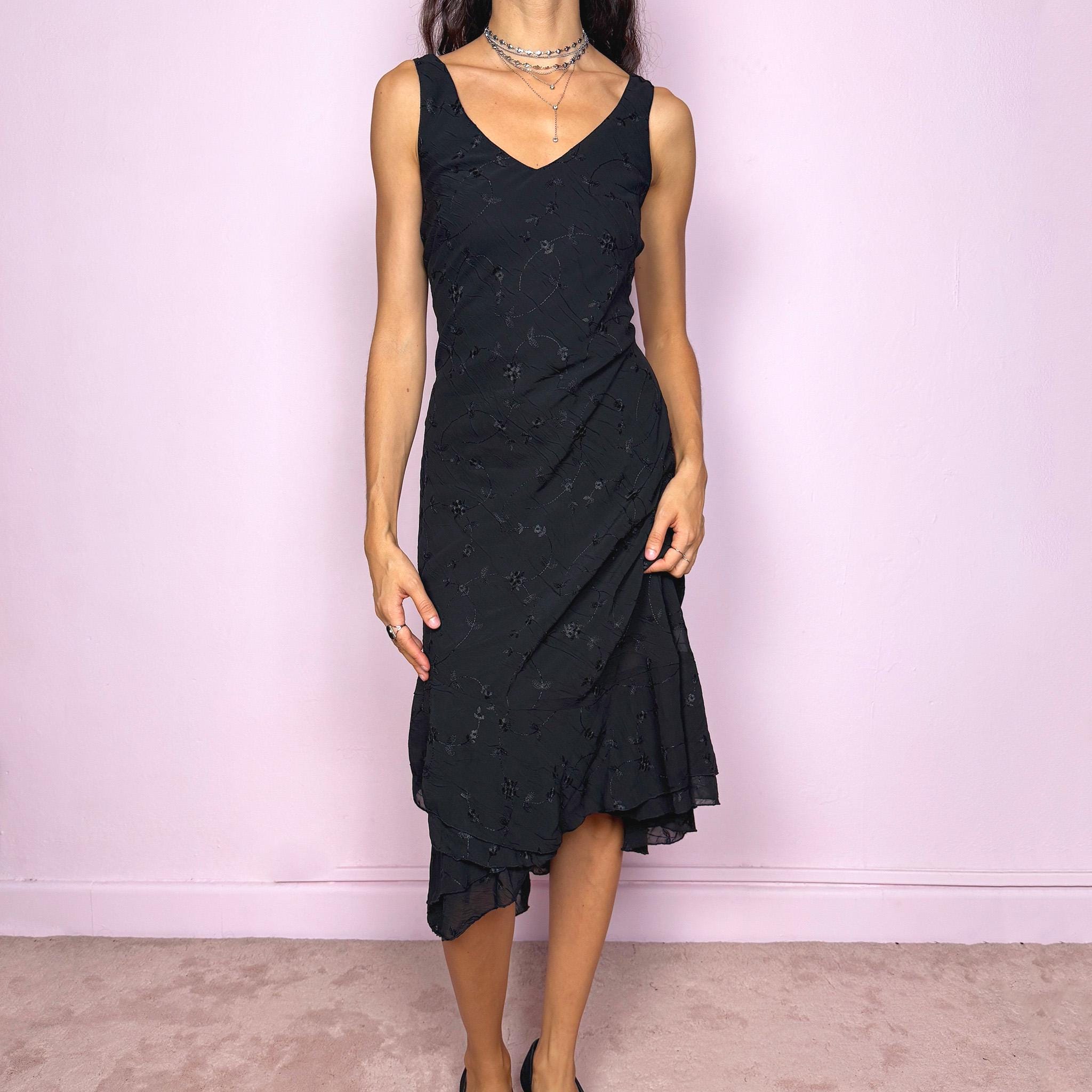 Romantic vintage 2000s black midi dress featuring delicate floral embroidery, a sleeveless cut, a V-neckline and an asymmetrical layered ruffle hem. The slightly stretchy fabric offers a comfortable, flattering fit with a minimal yet elegant look, perfect for a summer night event. Made in Spain from polyester. Excellent vintage condition.
