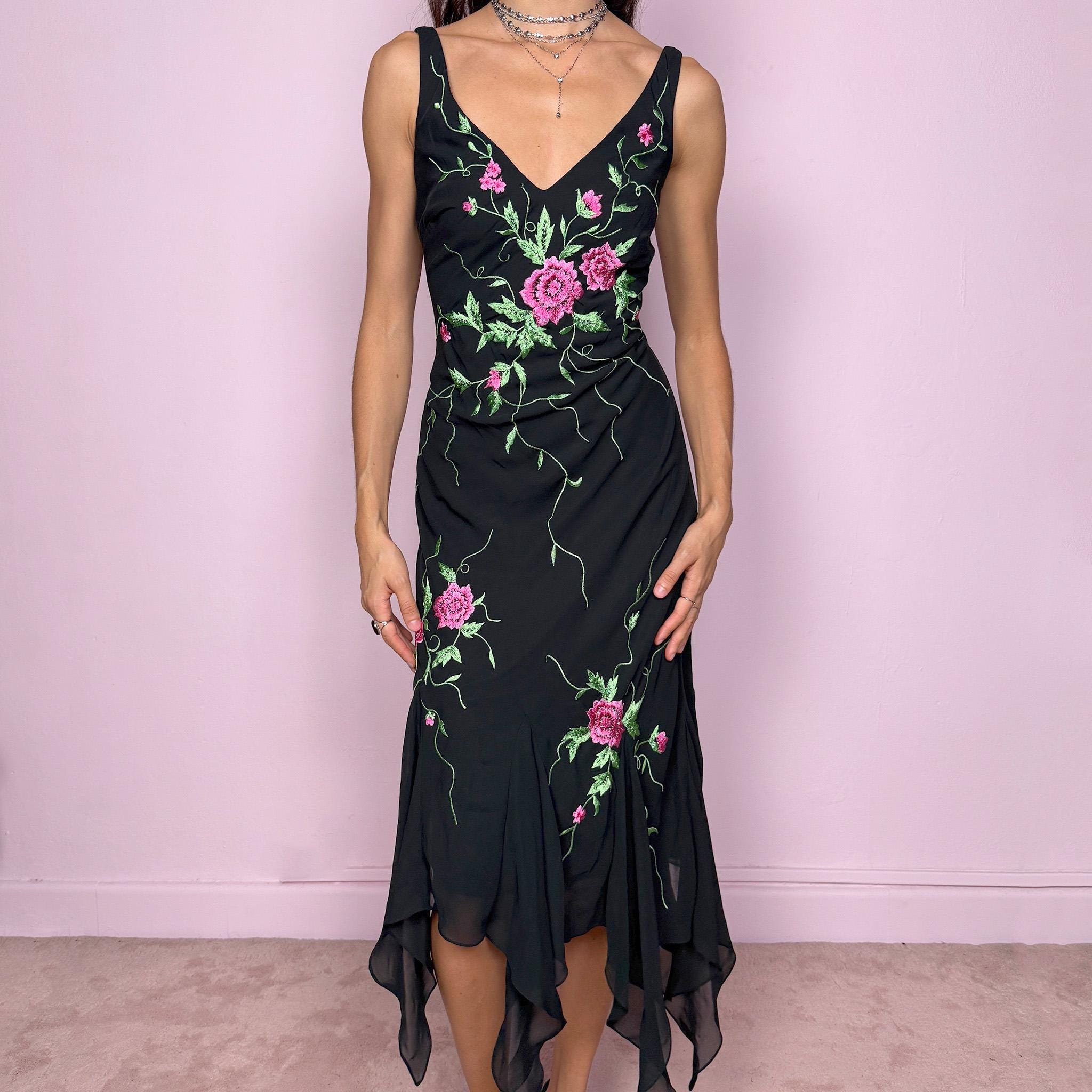 Stunning vintage 2000s black sleeveless V-neck long midi dress featuring pink and green floral embroidered details with beaded accents. The asymmetric handkerchief-style hem adds movement and a romantic statement look, perfect for gala events, formal parties or night occasions. Made from polyester. Excellent vintage condition.