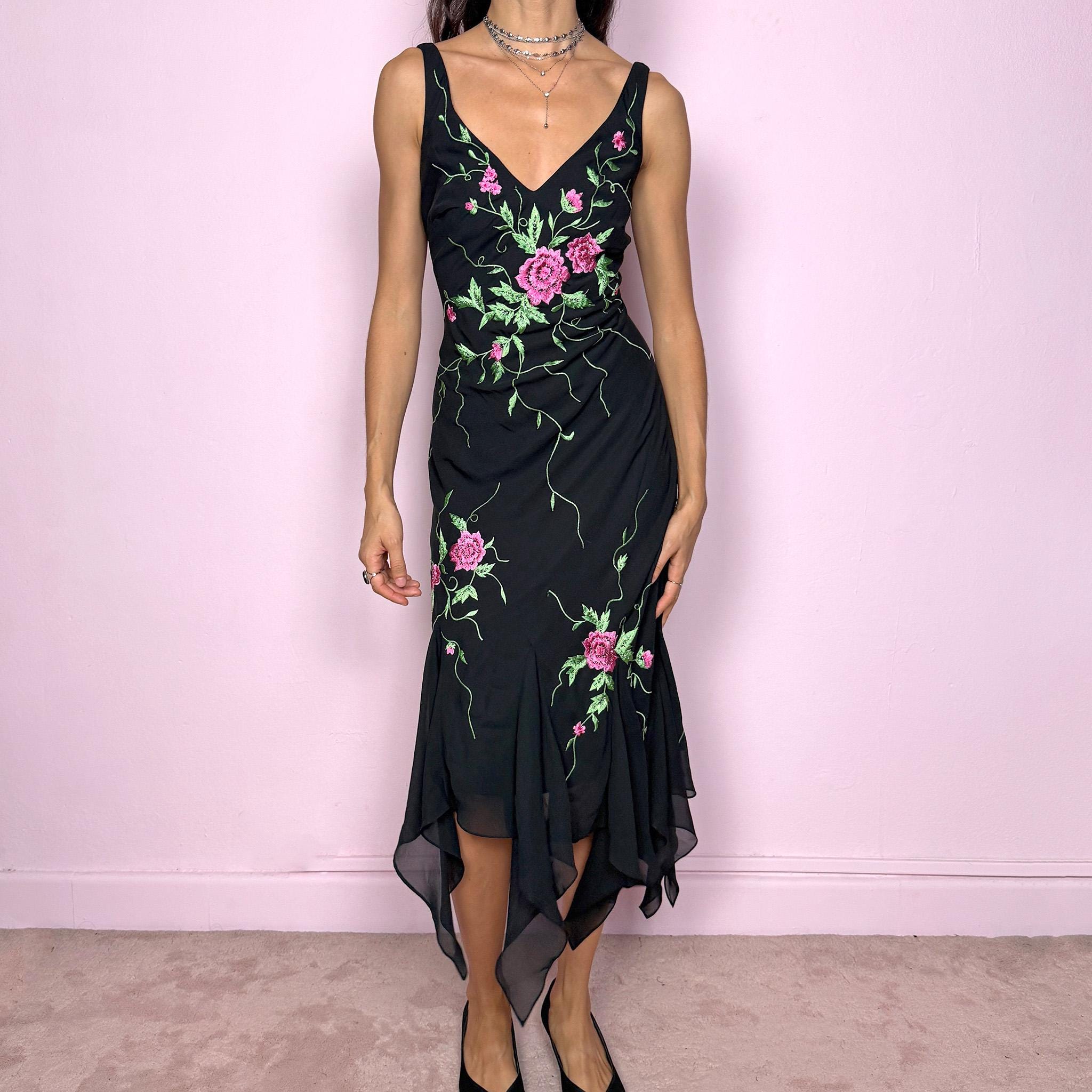 Stunning vintage 2000s black sleeveless V-neck long midi dress featuring pink and green floral embroidered details with beaded accents. The asymmetric handkerchief-style hem adds movement and a romantic statement look, perfect for gala events, formal parties or night occasions. Made from polyester. Excellent vintage condition.