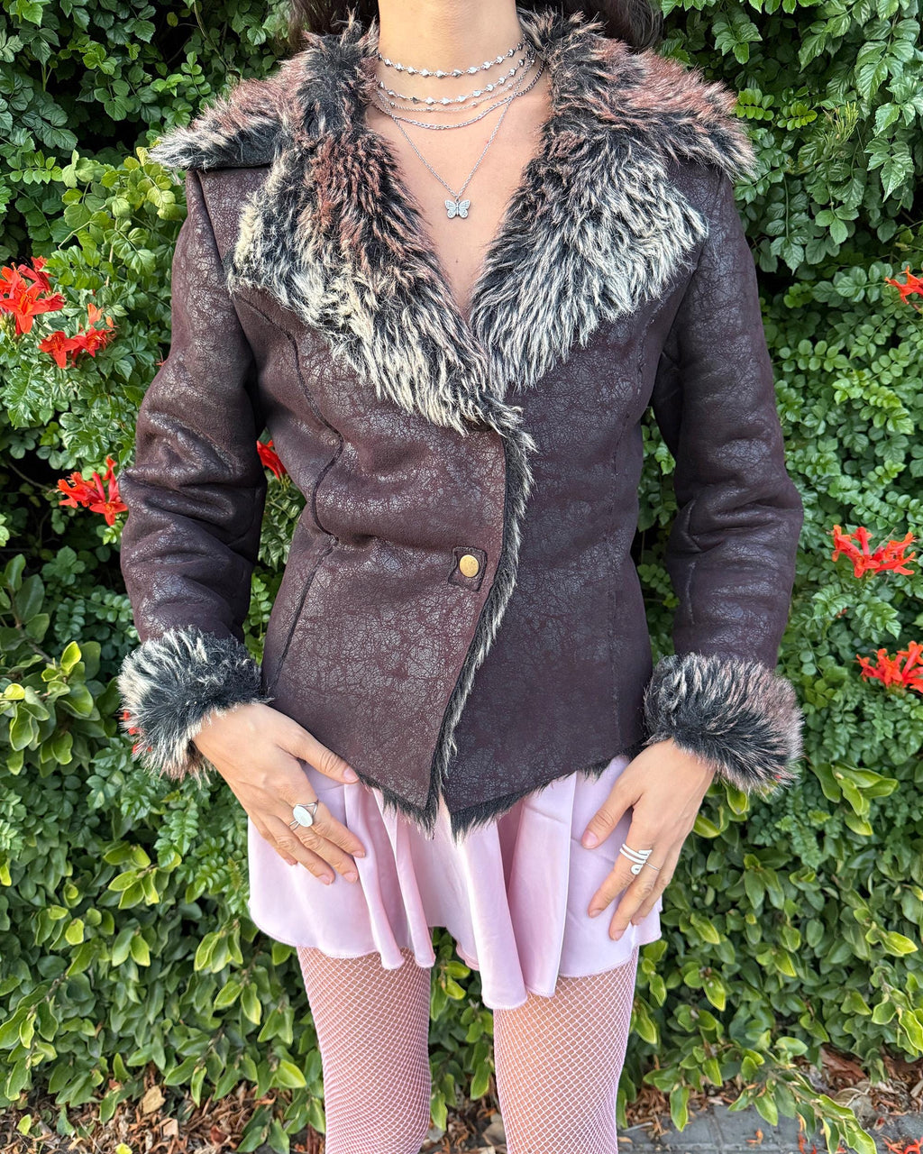 Stunning vintage 2000s dark brown–burgundy Penny Lane–style jacket featuring a distressed faux-leather exterior with full beige–brown–black faux-fur lining. Designed with a dramatic faux-fur trimmed collar and cuffs, shaped seams for a fitted silhouette and a two snap-button closure. The polyester-blend fabric has no stretch and delivers a warm, cozy feel perfect for winter layering. A French-design cyber streetwear and grunge statement coat ideal for night outings and bold Y2K styling.