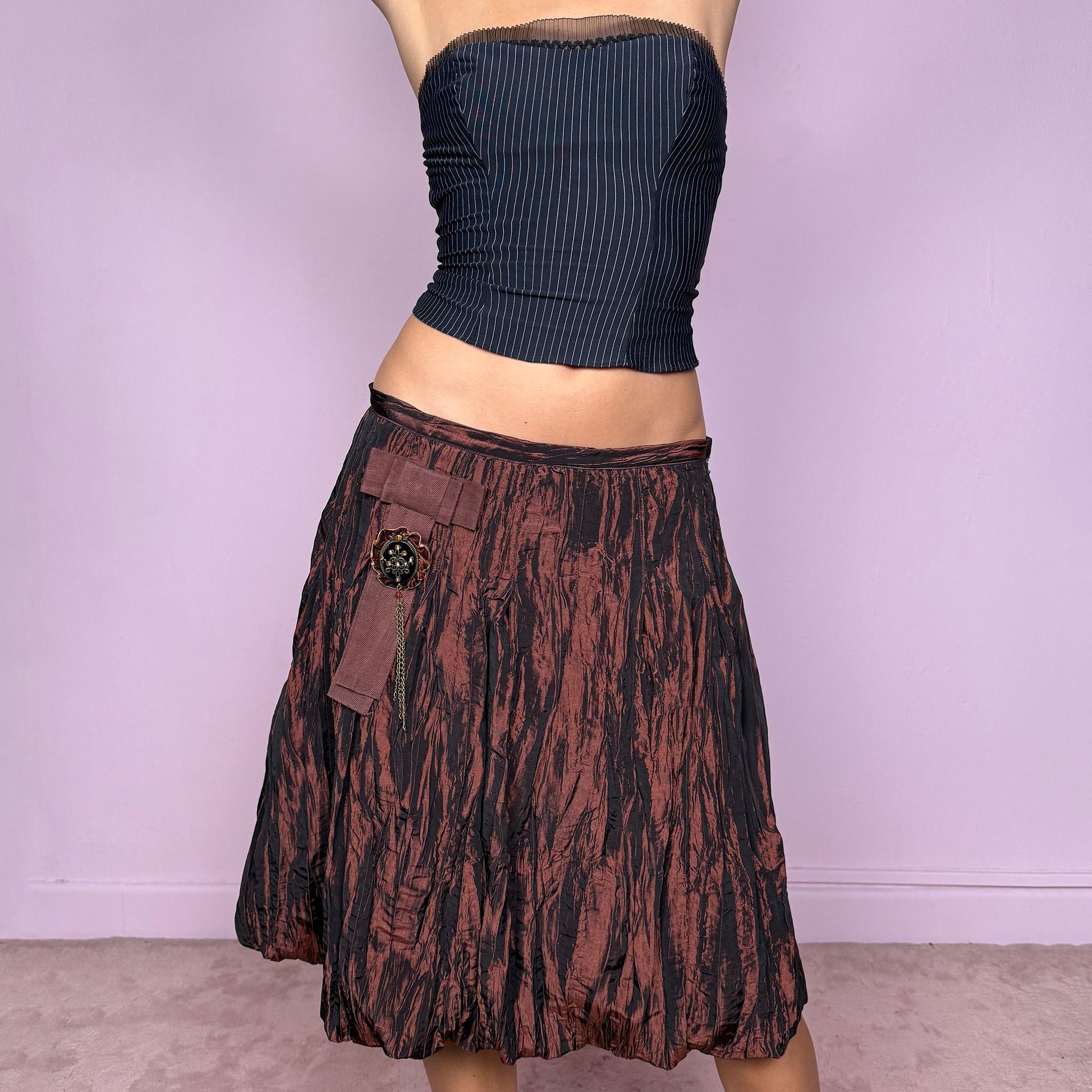 This vintage 90s crinkle-pleated brown balloon mini skirt features a dramatic bubble hem, side zipper closure, and sculptural volume. Designed for 80s-inspired forest fairy glamour, whimsical party nights, or bold formal styling. A rare archival piece for expressive evening wear. Fits high waisted for size L and mid rise for size M. Excellent vintage condition.