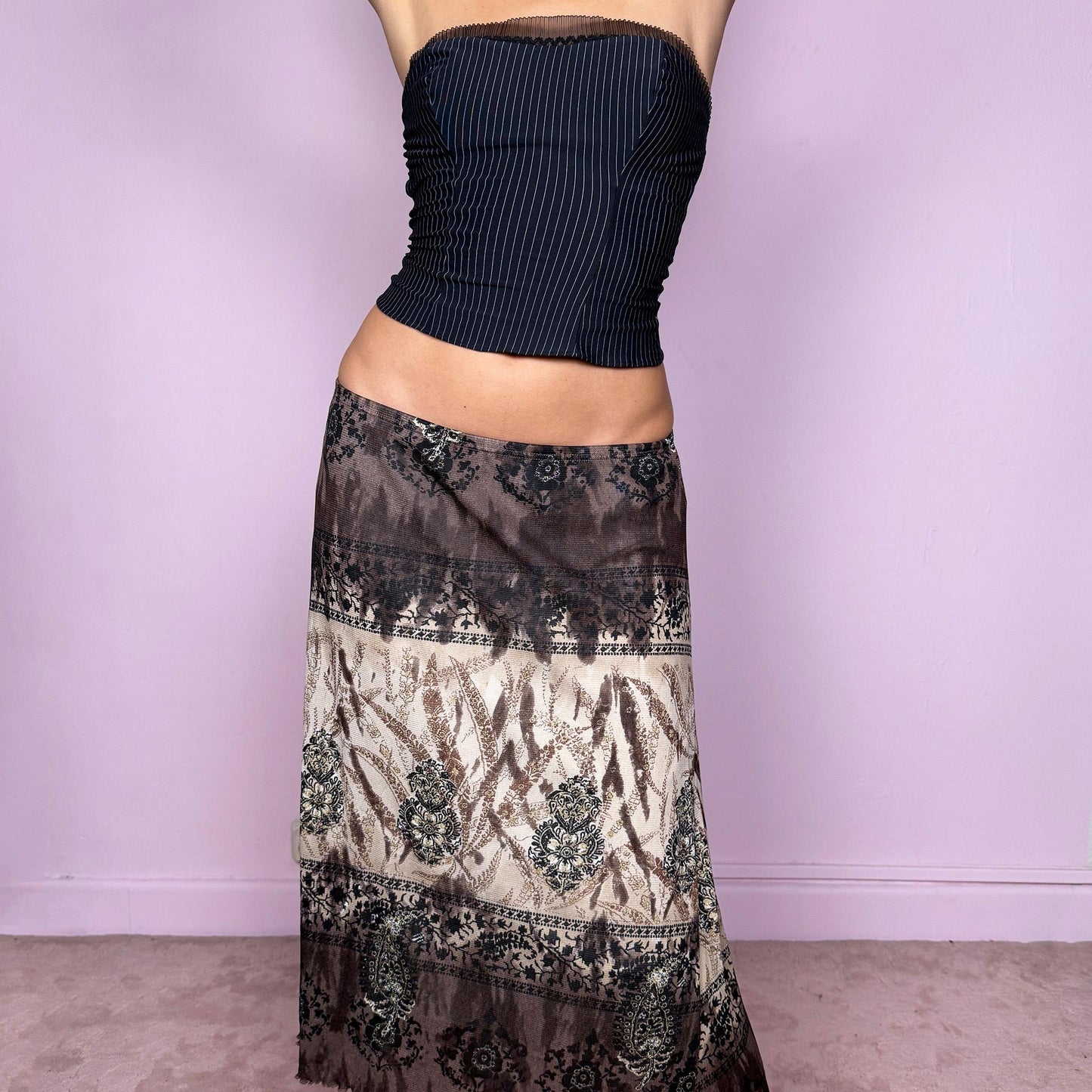 This vintage 2000s brown and beige abstract graphic print mesh midi skirt features glitter accents, a flowy silhouette, and soft elastic waist. A whimsical fairy-grunge piece blending Y2K pixie energy with earthy tones—perfect for spring or autumn layering and everyday statement wear. Ethereal and romantic. It fits high rise or low rise for size M and low rise for size S. Made from polyamide mesh. Excellent vintage condition.