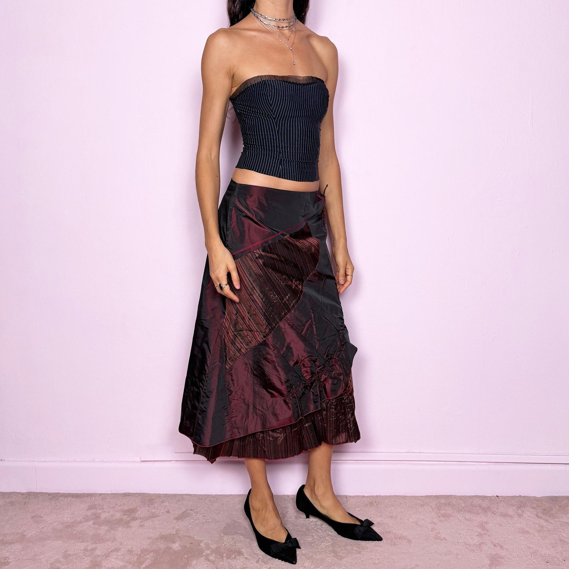 This stunning vintage 2000s maroon-burgundy flared midi skirt features a layered patchwork design with ruched detailing, ruffle hem, and back zipper closure. A whimsical fusion of fairy-grunge and deconstructed Y2K elegance, perfect for autumn nights, creative gatherings, or statement everyday wear. A rare, collectible piece with dark romance allure. It can be worn low to mid rise for size XS/S or high waisted for size M. Made from polyester acetate blend. Excellent vintage condition.