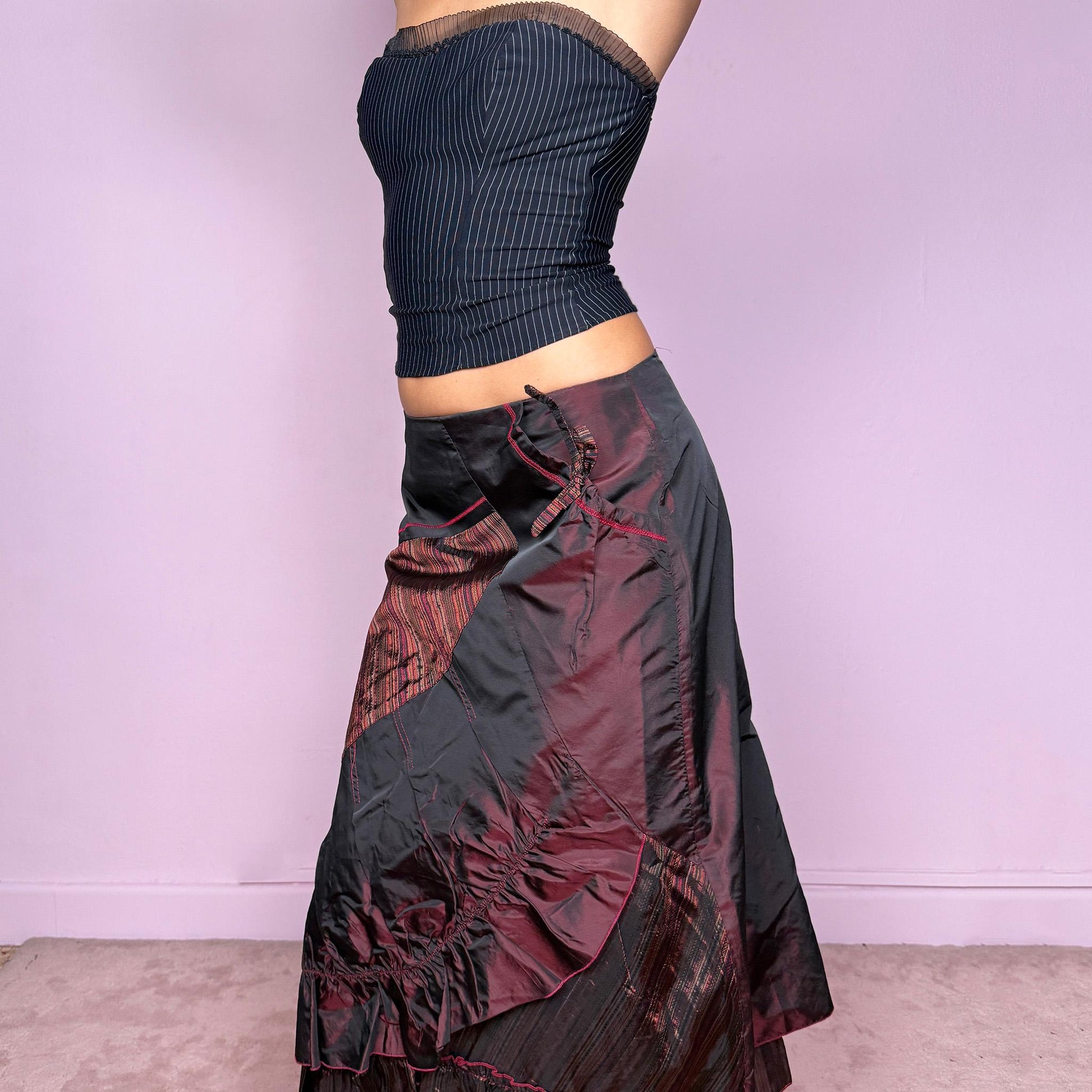This stunning vintage 2000s maroon-burgundy flared midi skirt features a layered patchwork design with ruched detailing, ruffle hem, and back zipper closure. A whimsical fusion of fairy-grunge and deconstructed Y2K elegance, perfect for autumn nights, creative gatherings, or statement everyday wear. A rare, collectible piece with dark romance allure. It can be worn low to mid rise for size XS/S or high waisted for size M. Made from polyester acetate blend. Excellent vintage condition.