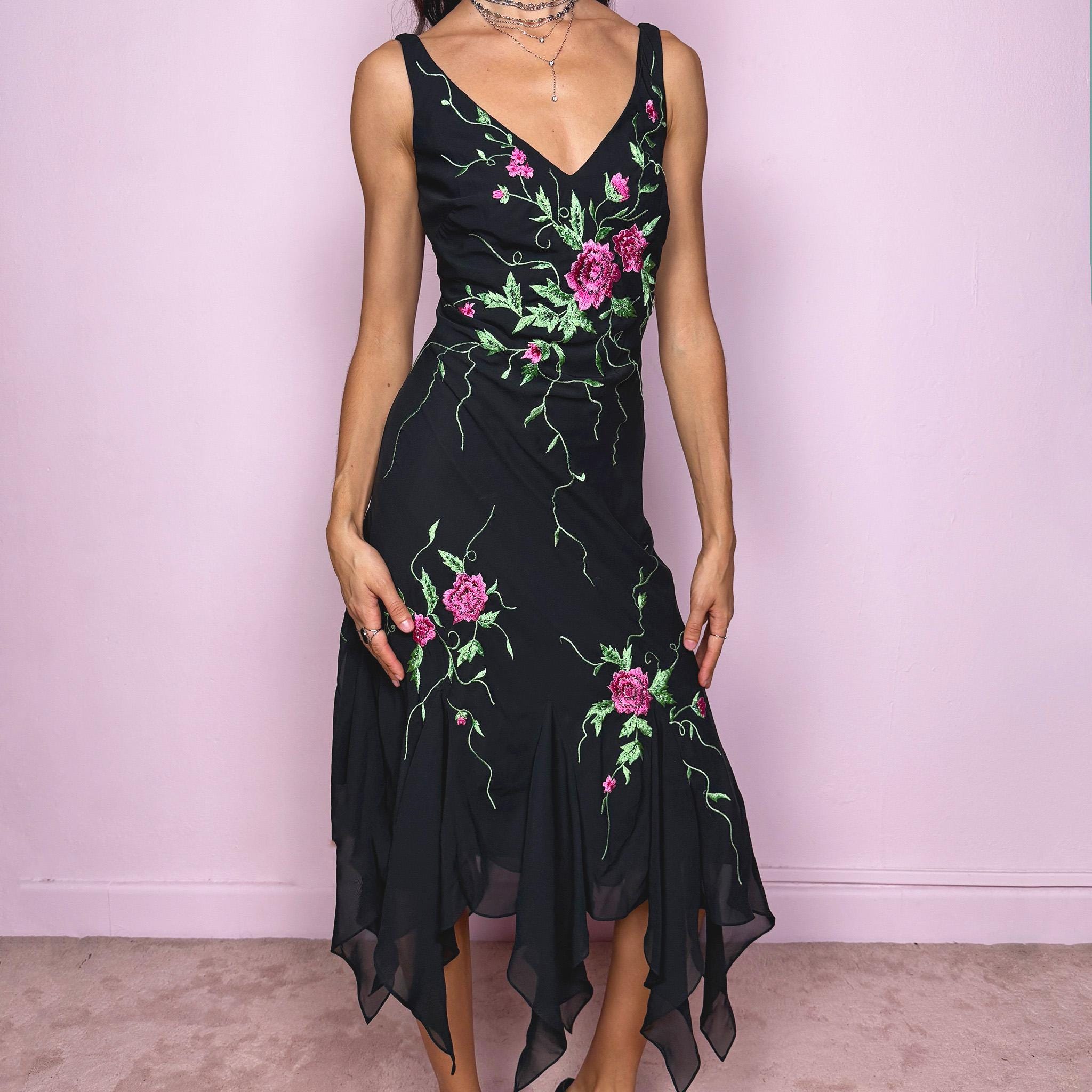 Stunning vintage 2000s black sleeveless V-neck long midi dress featuring pink and green floral embroidered details with beaded accents. The asymmetric handkerchief-style hem adds movement and a romantic statement look, perfect for gala events, formal parties or night occasions. Made from polyester. Excellent vintage condition.