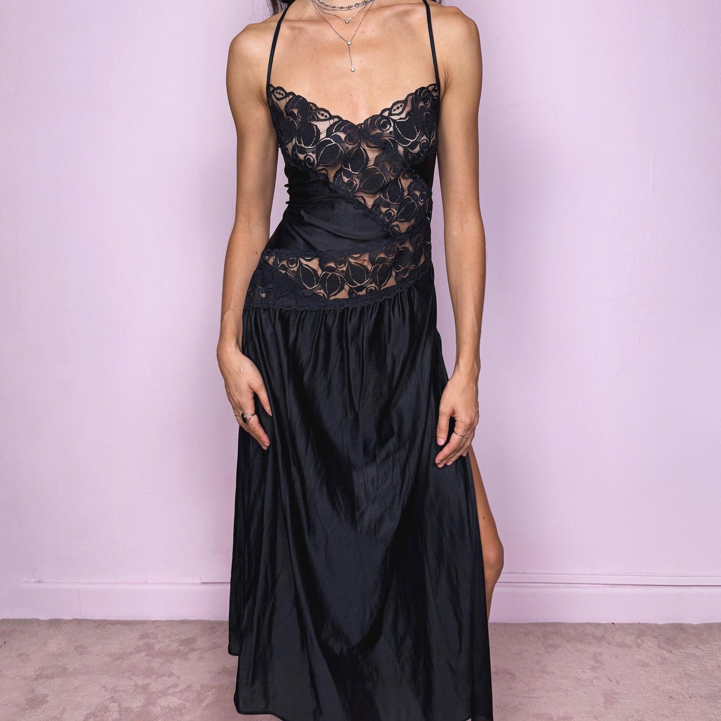 Stunning romantic vintage 2000s black long midi slip dress featuring lace details and an exaggerated side slit. The soft, fluid fabric creates a feminine, lingerie-inspired silhouette that works as a nightgown-style lounge piece, a date-night dress or an edgy night-out party look. The design has a refined, delicate and subtly seductive finish while remaining comfortable and wearable. Excellent vintage condition.