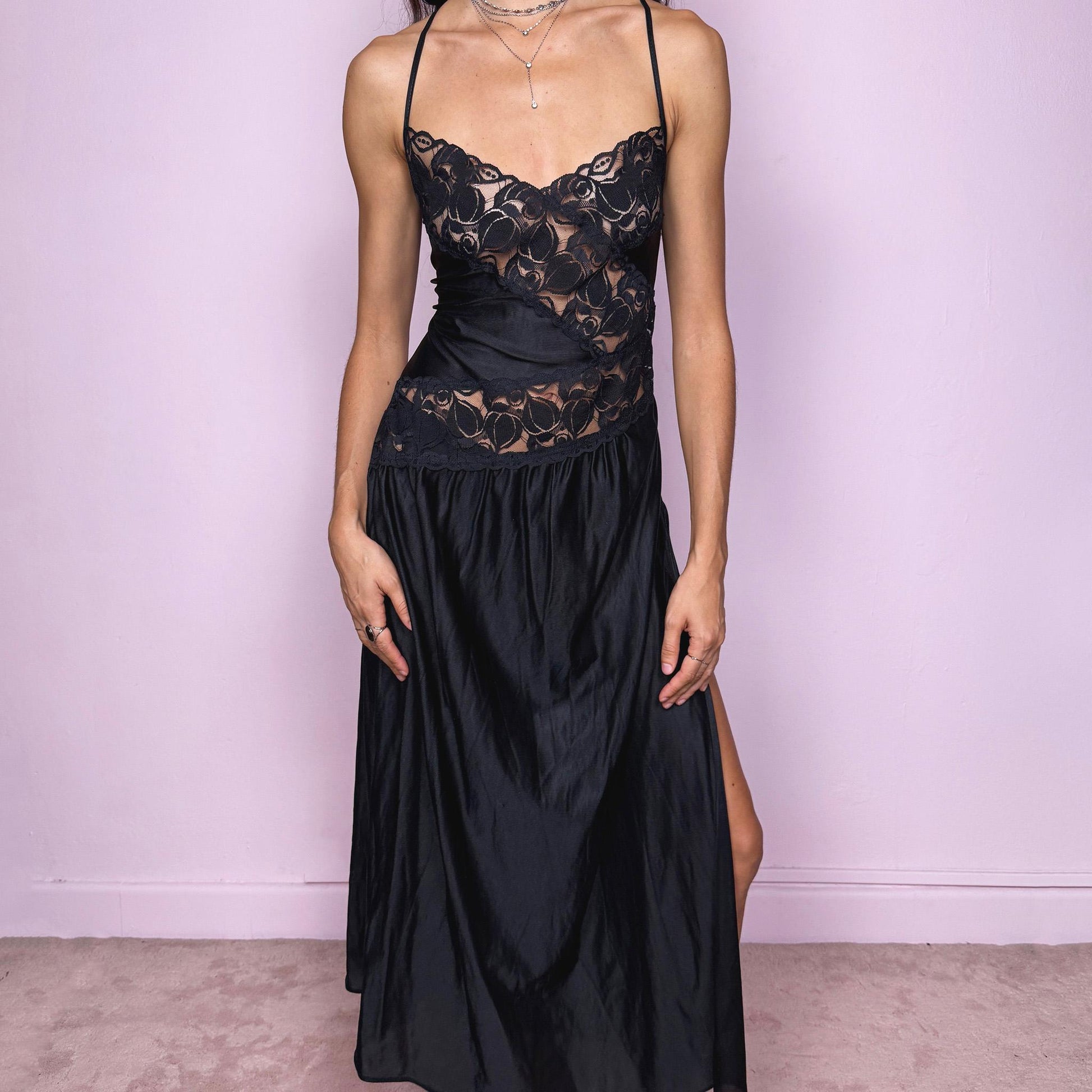 Stunning romantic vintage 2000s black long midi slip dress featuring lace details and an exaggerated side slit. The soft, fluid fabric creates a feminine, lingerie-inspired silhouette that works as a nightgown-style lounge piece, a date-night dress or an edgy night-out party look. The design has a refined, delicate and subtly seductive finish while remaining comfortable and wearable. Excellent vintage condition.