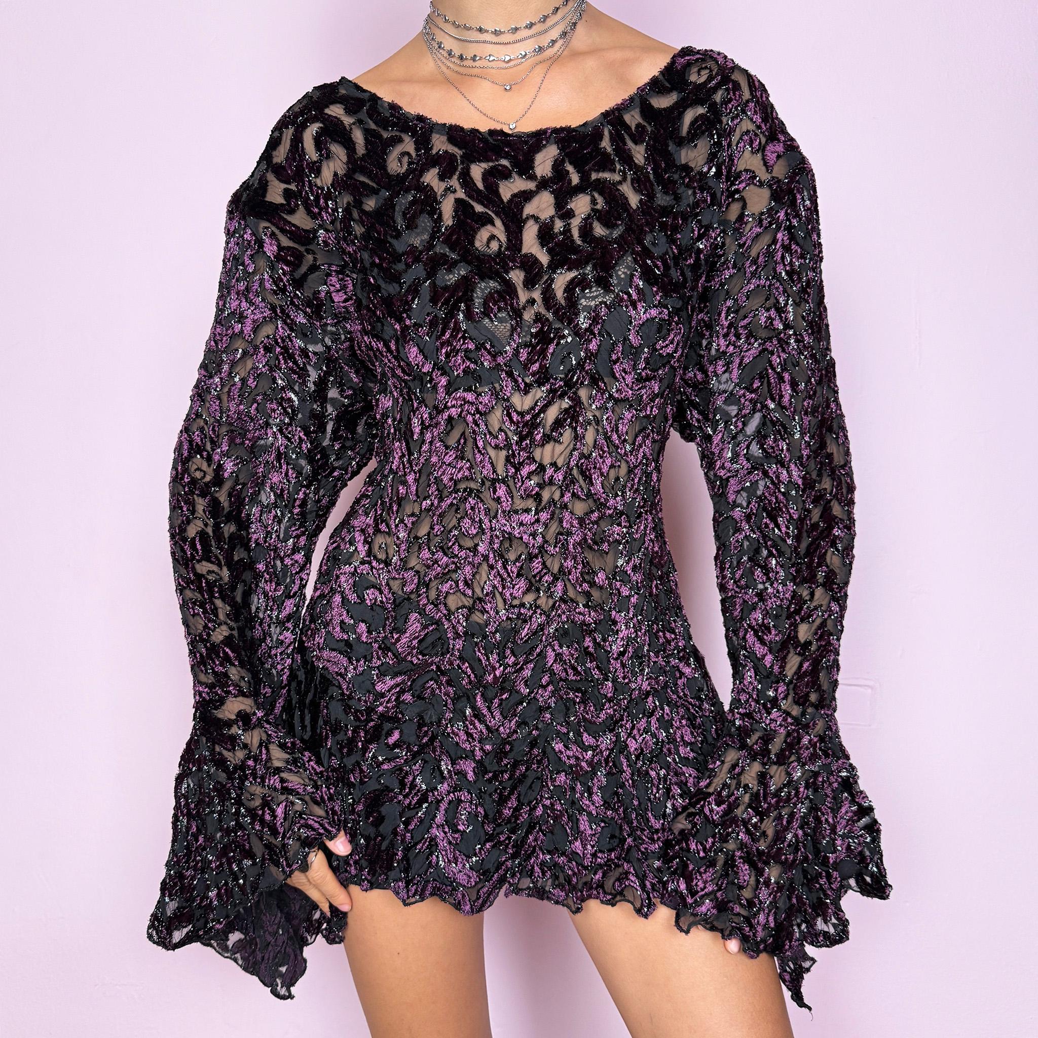 This vintage 2000s purple and black devoré velvet top delivers a dark romantic, witchy, goth aesthetic with a fitted bodice, sheer burnout pattern, metallic threads, asymmetric bell sleeves, and a flared hem. Ideal for evening styling, festivals, and statement layering. An archival French piece with a stretchy finish for comfortable wear. Excellent vintage condition.