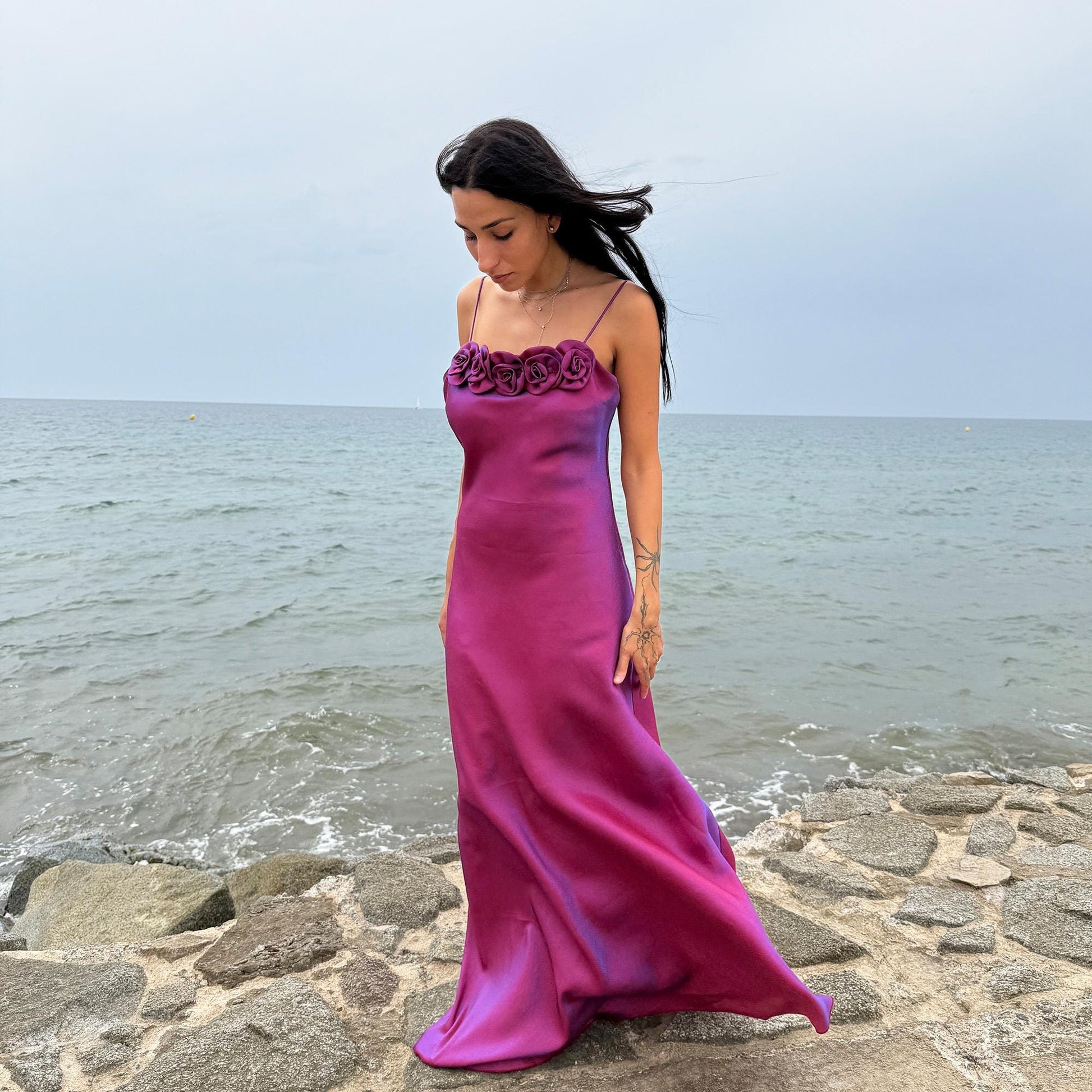 Vintage Y2K iridescent slip midi dress from the 2000s in a stunning maroon tone with blueish undertones that shift toward purple depending on light reflection. Features a sculptural rosette appliqué along the bust and spaghetti straps. The shimmering surface enhances its red carpet appeal, making it ideal for proms, summer weddings, gala events, or romantic evenings. Made in France from a non-stretch polyester viscose blend fabric. Great vintage condition.