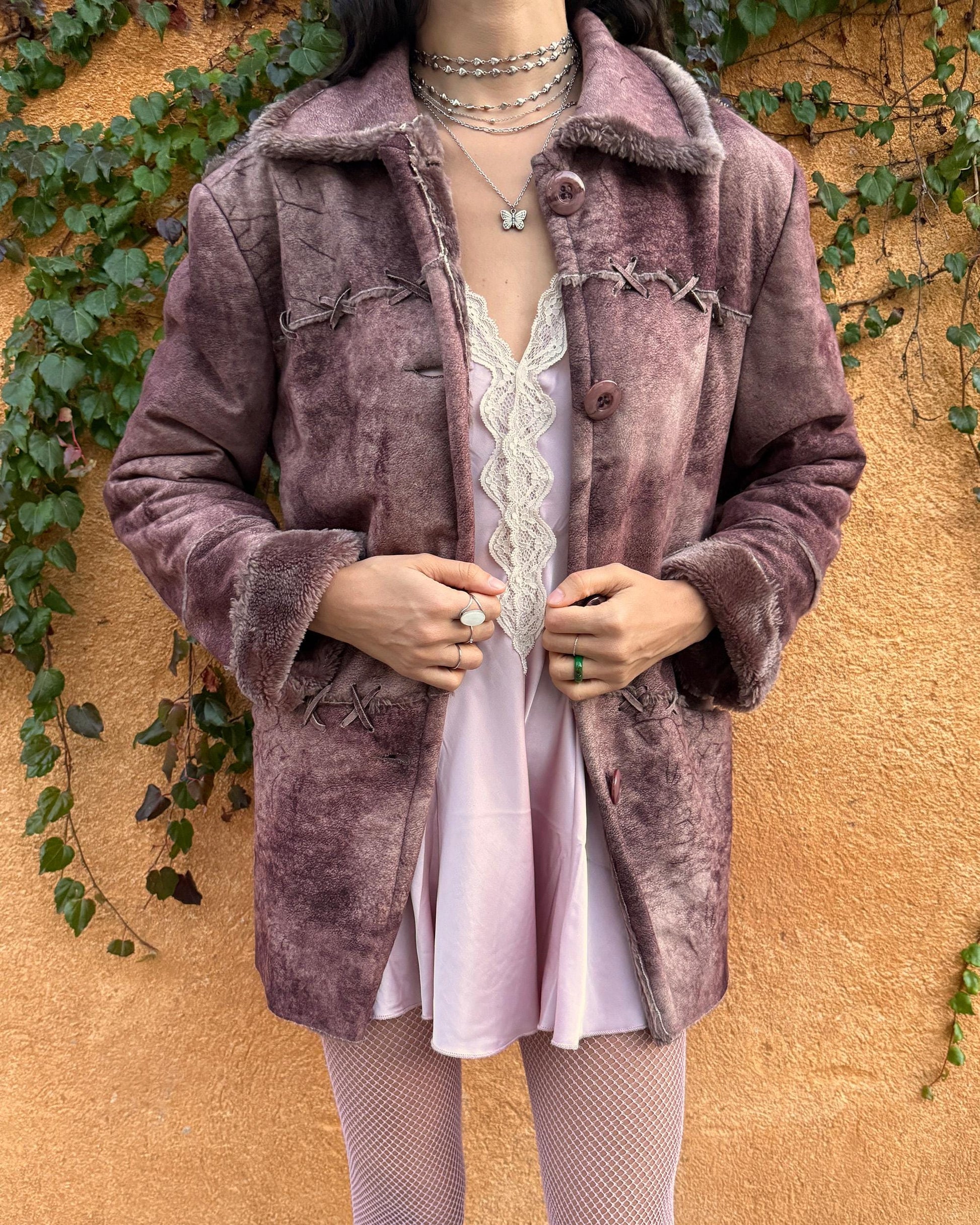 Vintage 2000s faux shearling coat in a rare reddish-brown (terracotta) tie-dye distressed finish. Features a faux fur collar and cuffs, button closure, side pockets, and decorative criss-cross stitch detailing for a dystopic cyber-grunge aesthetic. The straight silhouette makes it ideal for winter layering and festival styling. A standout 2000s piece for streetwear, weird-girl outfits, and bold cold-weather looks. Made from a polyester acrylic blend. Great vintage condition.