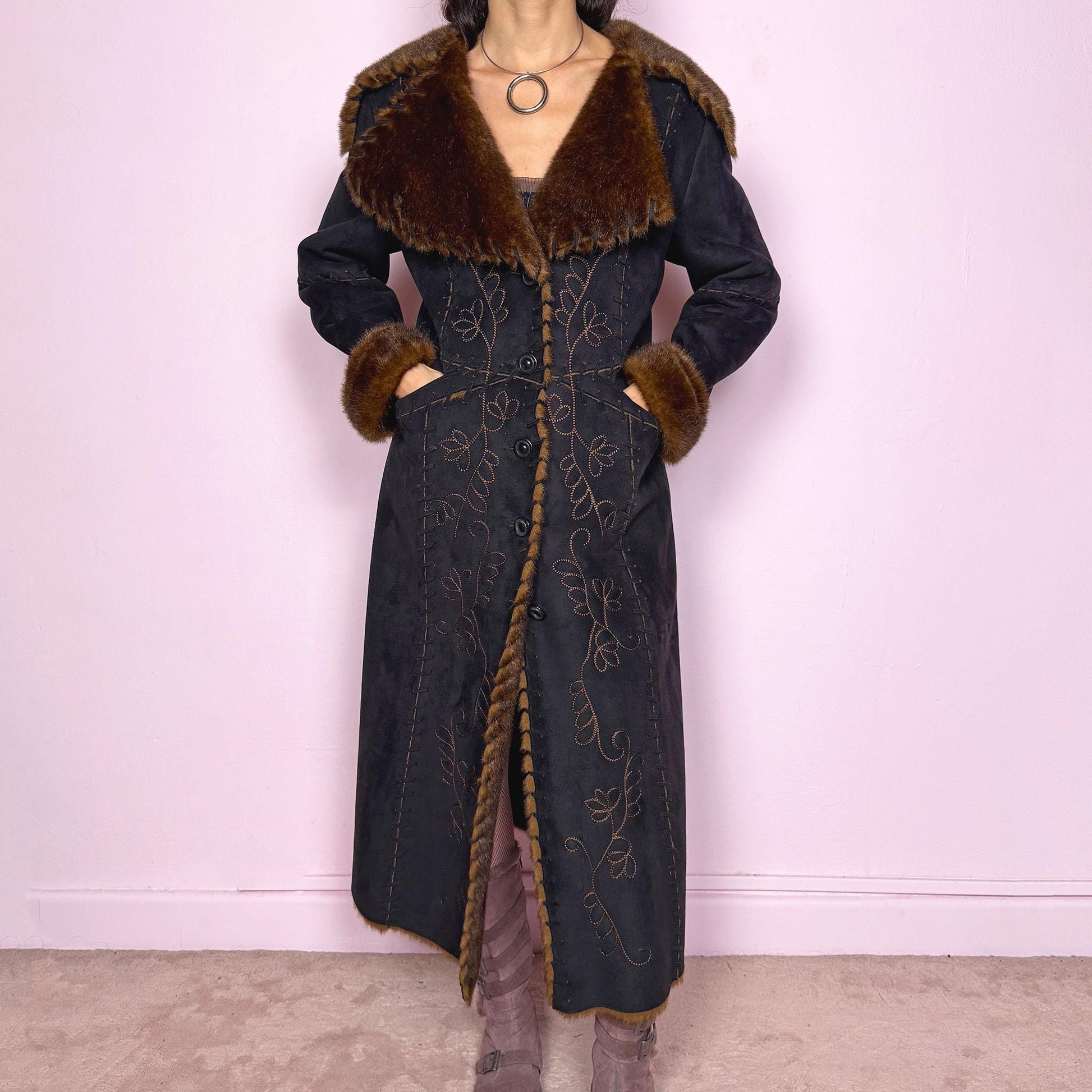 Stunning vintage 2000s dark gray almost black long Penny Lane coat with brown faux fur interior, collar, and cuffs. Features intricate floral embroidery, pockets, and button front closure. Soft faux suede with a warm feel, ideal for whimsical fairycore, boho, forest muse, and 70s Afghan-inspired Y2K styling. French-designed piece. Made from polyester. Excellent vintage condition.