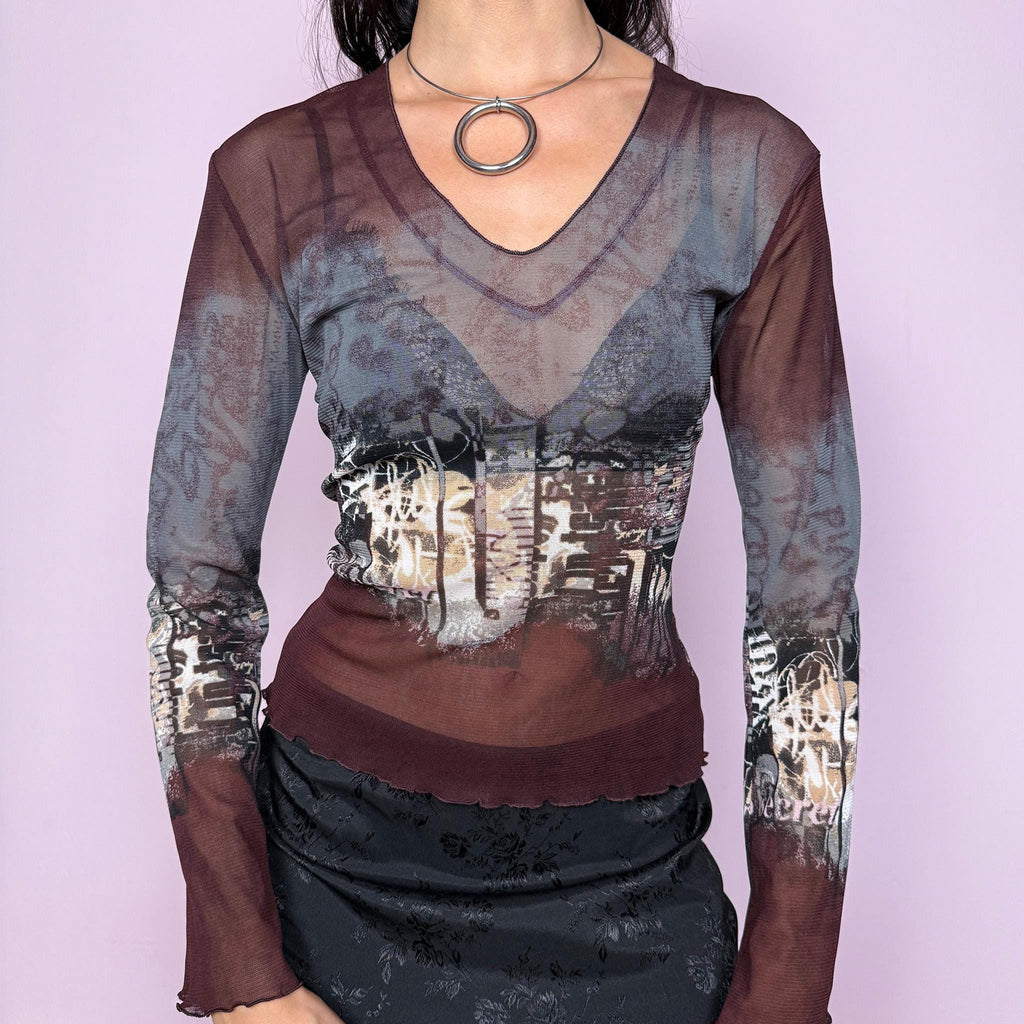 Vintage 2000s semi-sheer mesh top in gray and burgundy tones with an abstract city-inspired graphic print. Features a V neckline, long flared sleeves, and a stretchy fit. The deconstructed aesthetic give it a distinct cyber grunge and weird girl edge. Perfect for a casual yet statement everyday look. Excellent vintage condition.