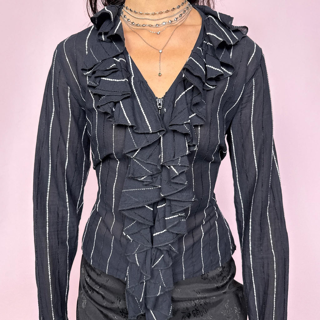 Avant-garde vintage 2000s dark navy blue (almost black) pinstripe blouse featuring a ruffled neckline and cuffs, front zip closure, and adjustable lace-up back for a perfectly tailored fit. The structured silhouette combines romantic detailing with formal edge, ideal for elegant office looks and evening dinners. Made from cotton and polyamide blend. Great vintage condition.