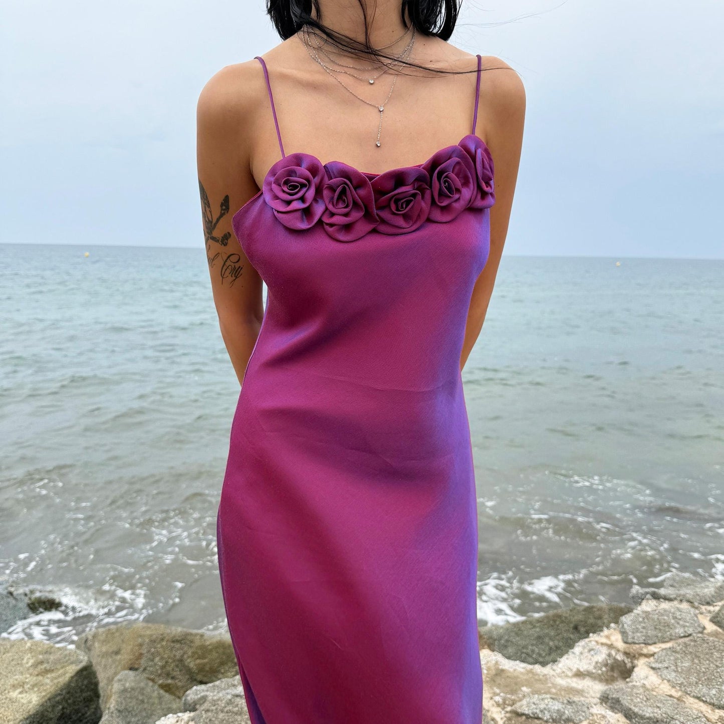 Vintage Y2K iridescent slip midi dress from the 2000s in a stunning maroon tone with blueish undertones that shift toward purple depending on light reflection. Features a sculptural rosette appliqué along the bust and spaghetti straps. The shimmering surface enhances its red carpet appeal, making it ideal for proms, summer weddings, gala events, or romantic evenings. Made in France from a non-stretch polyester viscose blend fabric. Great vintage condition.