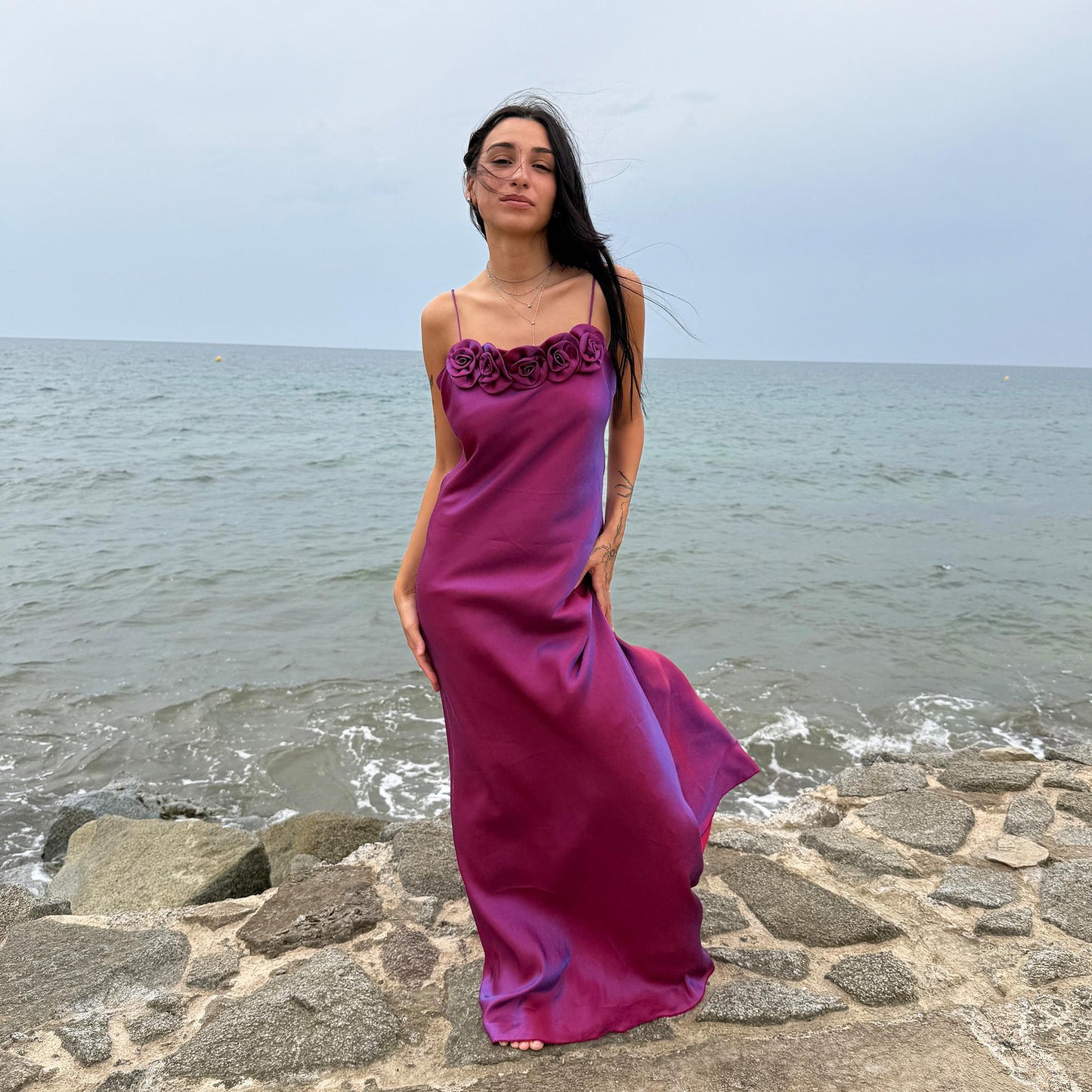 Vintage Y2K iridescent slip midi dress from the 2000s in a stunning maroon tone with blueish undertones that shift toward purple depending on light reflection. Features a sculptural rosette appliqué along the bust and spaghetti straps. The shimmering surface enhances its red carpet appeal, making it ideal for proms, summer weddings, gala events, or romantic evenings. Made in France from a non-stretch polyester viscose blend fabric. Great vintage condition.