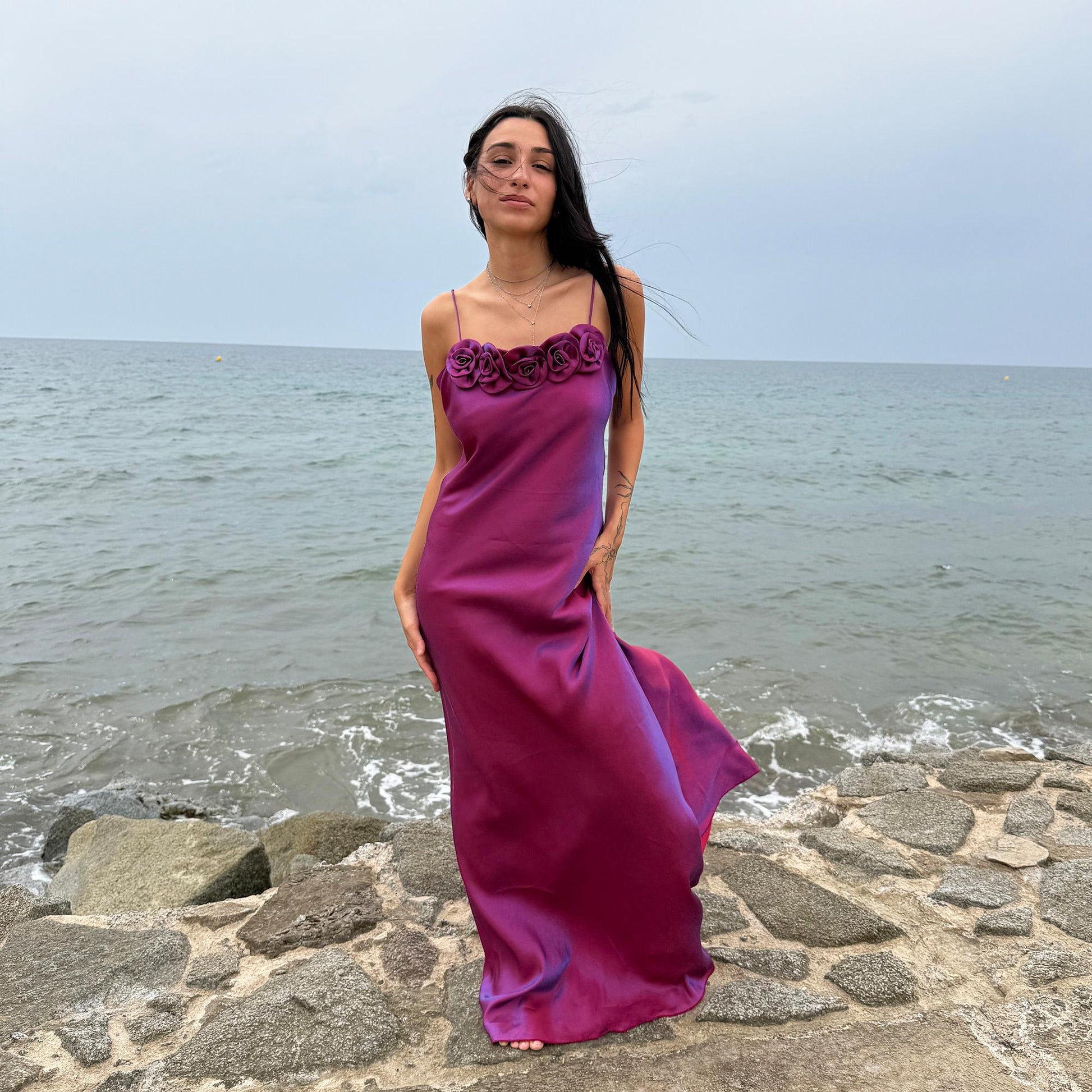 Vintage Y2K iridescent slip midi dress from the 2000s in a stunning maroon tone with blueish undertones that shift toward purple depending on light reflection. Features a sculptural rosette appliqué along the bust and spaghetti straps. The shimmering surface enhances its red carpet appeal, making it ideal for proms, summer weddings, gala events, or romantic evenings. Made in France from a non-stretch polyester viscose blend fabric. Great vintage condition.