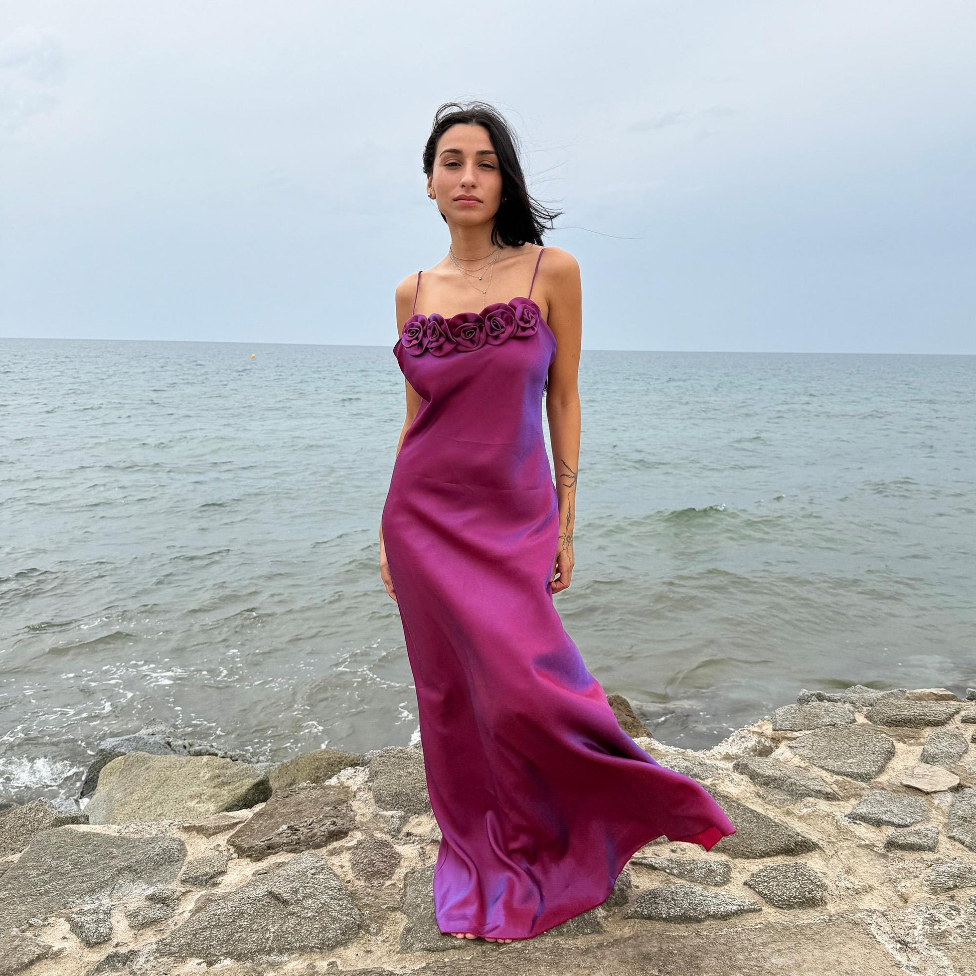 Vintage Y2K iridescent slip midi dress from the 2000s in a stunning maroon tone with blueish undertones that shift toward purple depending on light reflection. Features a sculptural rosette appliqué along the bust and spaghetti straps. The shimmering surface enhances its red carpet appeal, making it ideal for proms, summer weddings, gala events, or romantic evenings. Made in France from a non-stretch polyester viscose blend fabric. Great vintage condition.