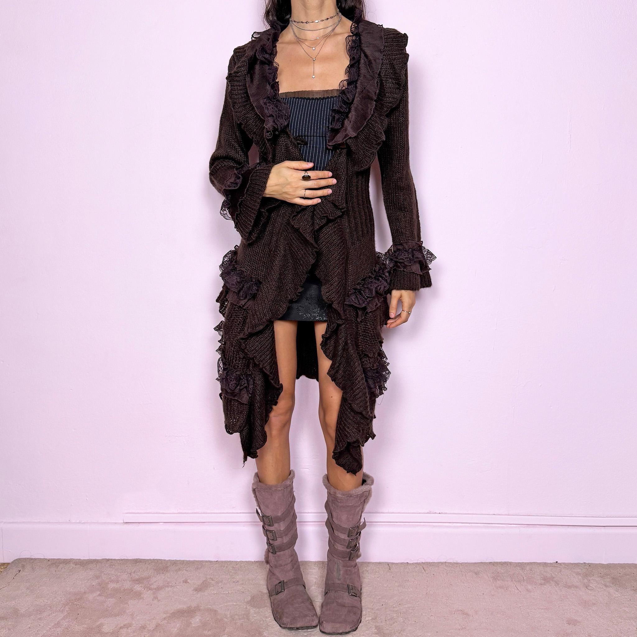 Romantic vintage 2000s dark brown longline cardigan with dramatic ruffle neckline and lace details. Features bell sleeves with ruffle cuffs, toggle front closure, and asymmetric pointy hem. Whimsical fairycore silhouette with dark baroque rococo style. Stretchy fabric for cozy winter layering. Made from acrylic mohair wool blend. Excellent vintage condition.