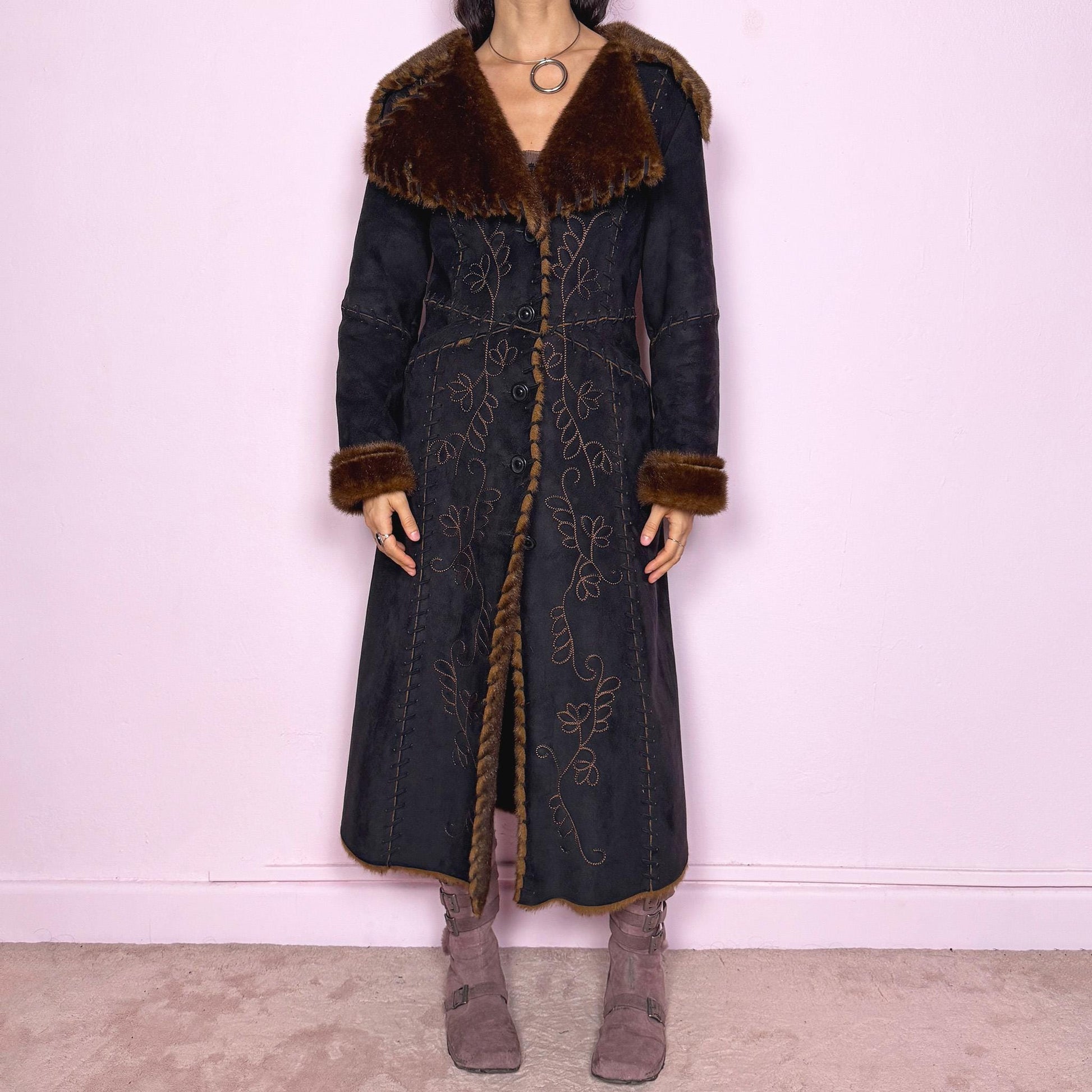 Stunning vintage 2000s dark gray almost black long Penny Lane coat with brown faux fur interior, collar, and cuffs. Features intricate floral embroidery, pockets, and button front closure. Soft faux suede with a warm feel, ideal for whimsical fairycore, boho, forest muse, and 70s Afghan-inspired Y2K styling. French-designed piece. Made from polyester. Excellent vintage condition.