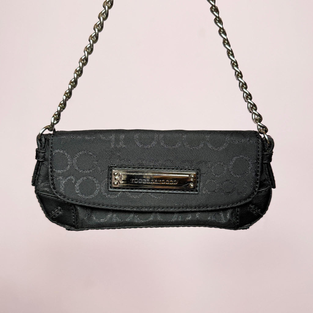 Vintage Y2K black mini baguette bag with shiny monogram finish, snap button closure, and chain shoulder strap. Iconic 2000s Italian design by Roccobarroco, ideal for party nights, events, and elegant glam Y2K styling. Made from polyester. Excellent vintage condition.