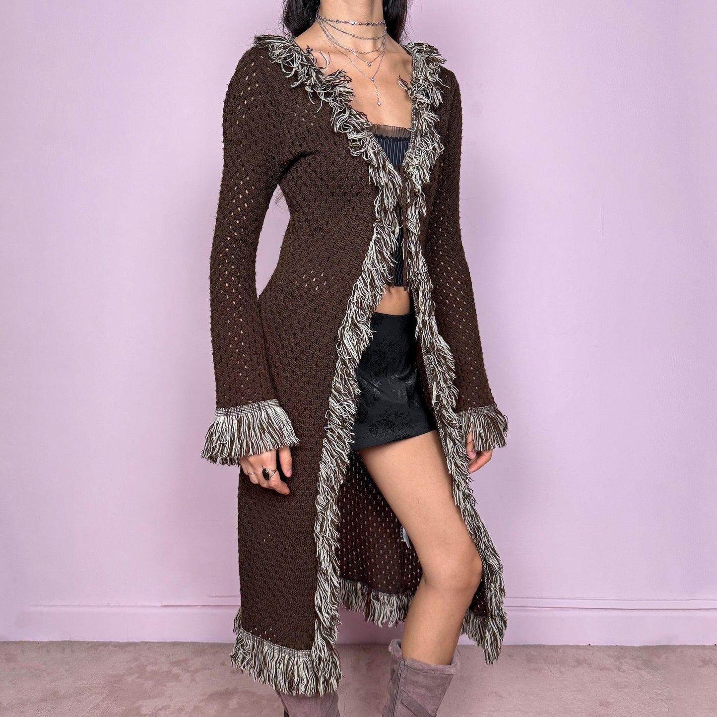 Vintage 90s brown longline cardigan with open knit semi-sheer construction and tie front closure. Features shaggy beige and brown trim along the neckline, cuffs, and hem, with long sleeves and a stretchy comfy fit. Ideal for boho fairycore party looks, festival outfits, or autumn layering. Great vintage condition.