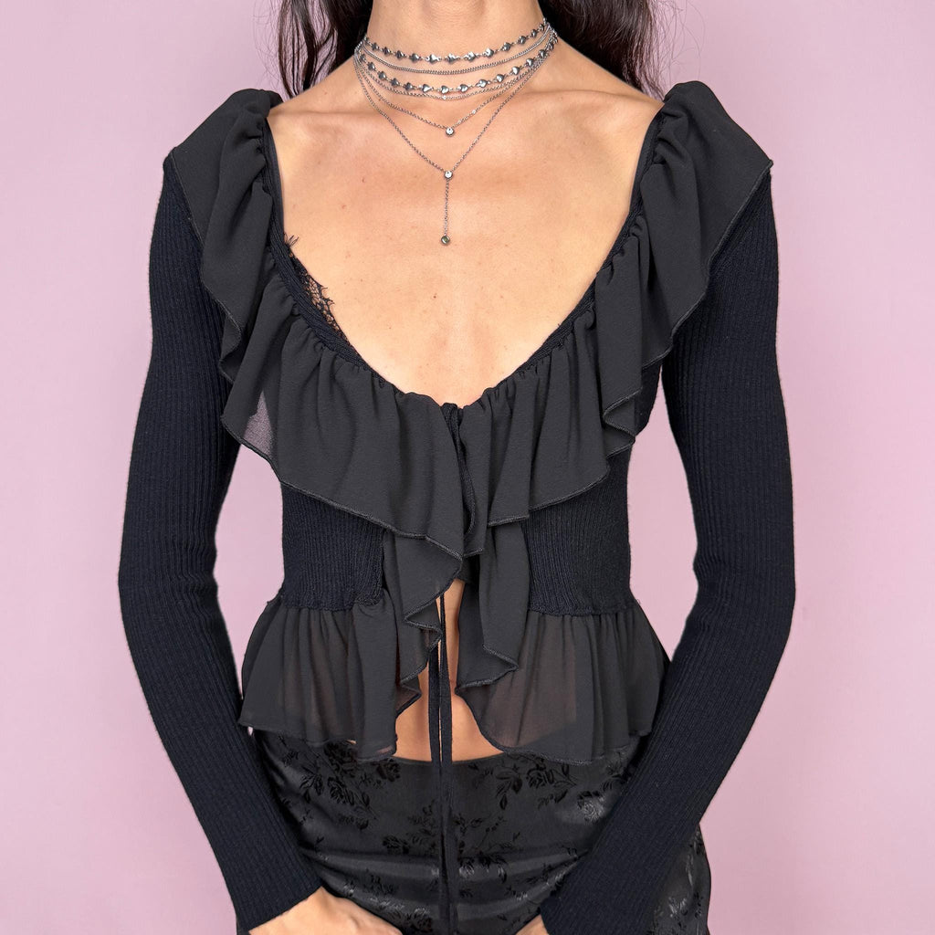 Dark romance vintage 2000s black ribbed knit long sleeve tie-front cropped cardigan with ruffle neckline and hem. Feminine coquette goth bolero style layering jacket with a stretchy fit. Made in Italy by an Italian brand from Polyamide, Polyester, and Viscose. Excellent vintage condition.