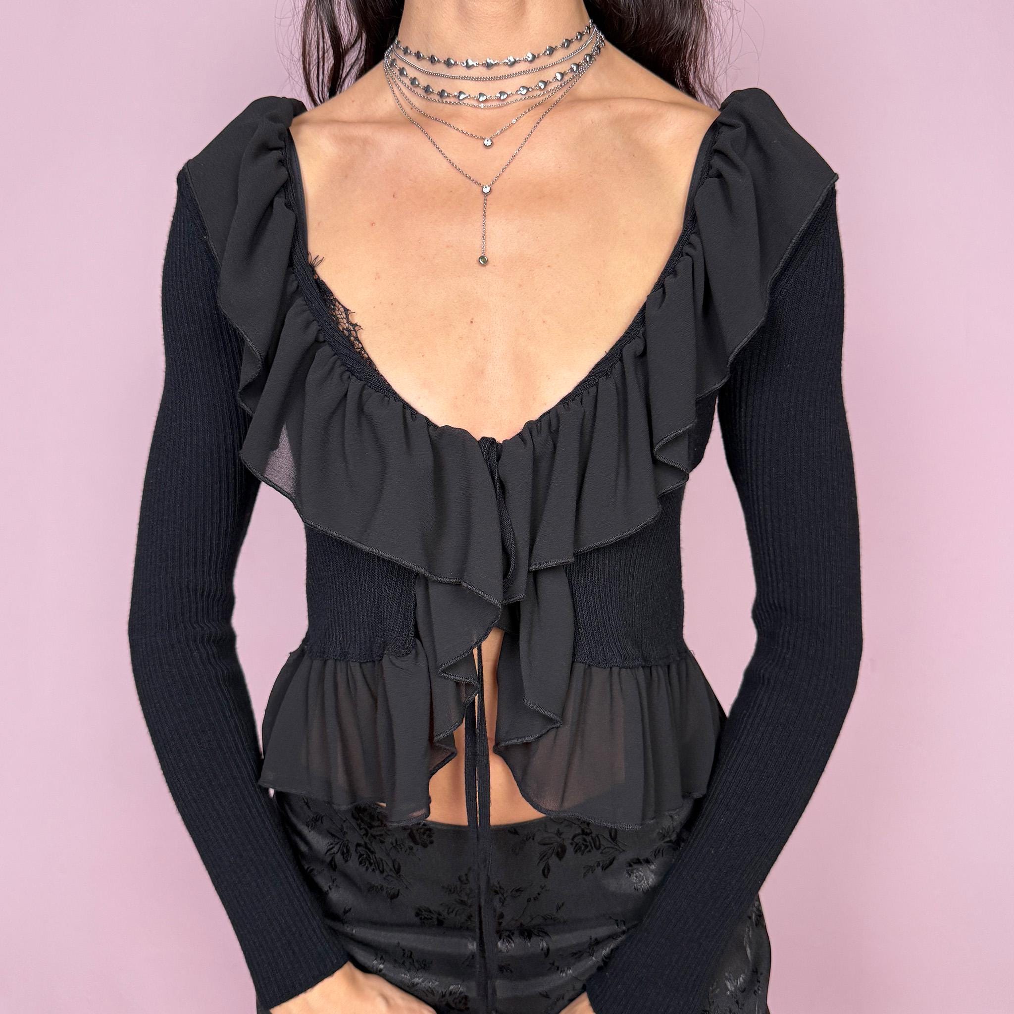Dark romance vintage 2000s black ribbed knit long sleeve tie-front cropped cardigan with ruffle neckline and hem. Feminine coquette goth bolero style layering jacket with a stretchy fit. Made in Italy by an Italian brand from Polyamide, Polyester, and Viscose. Excellent vintage condition.