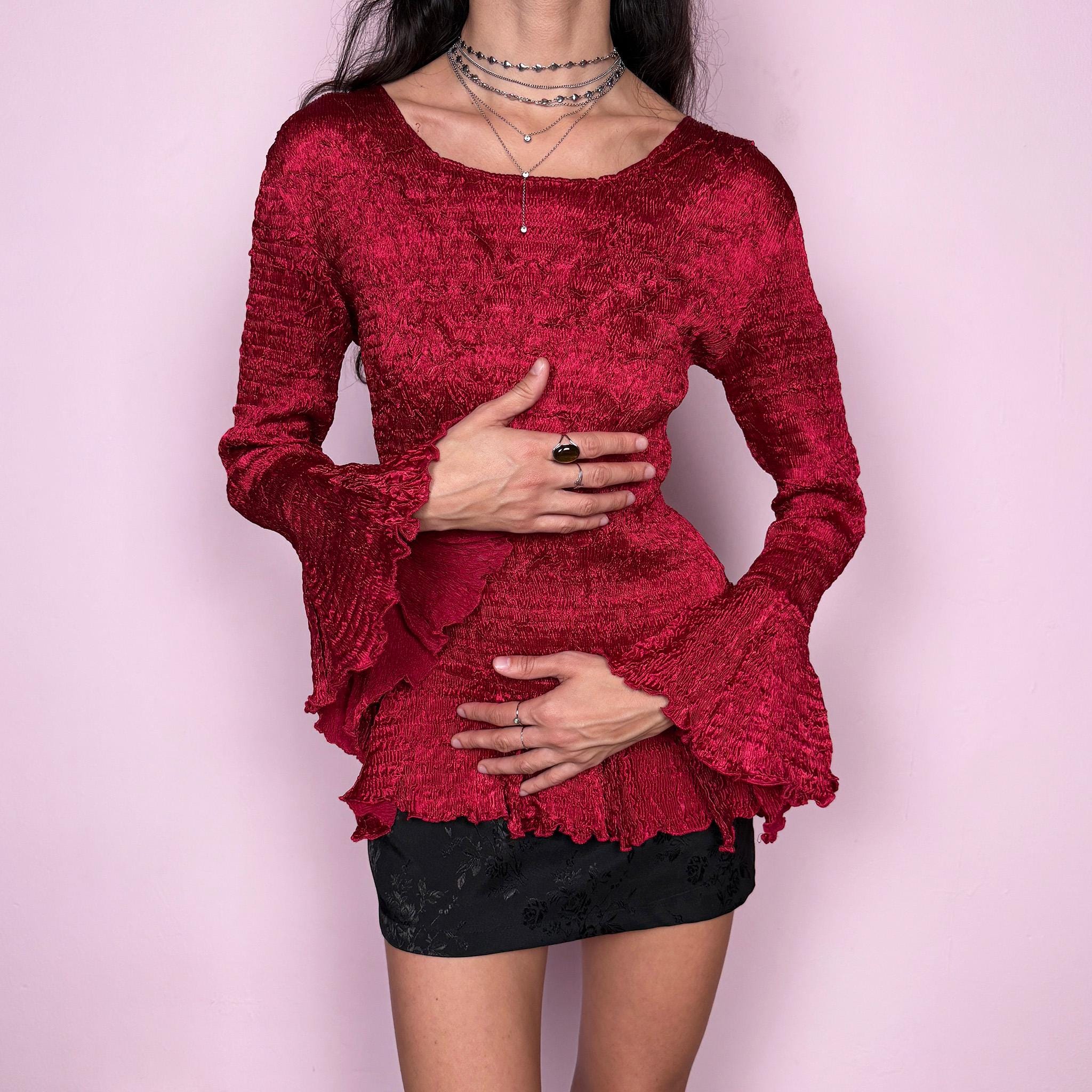 Stunning vintage 2000s burgundy maroon crinkle-pleated blouse featuring dramatic asymmetric bell sleeves, a fitted silhouette, and an asymmetric flared hem. Romantic and avant-garde, ideal for formal parties, festivals, or bold evening wear. Rare archival French design made from polyester by a French brand. Excellent vintage condition.