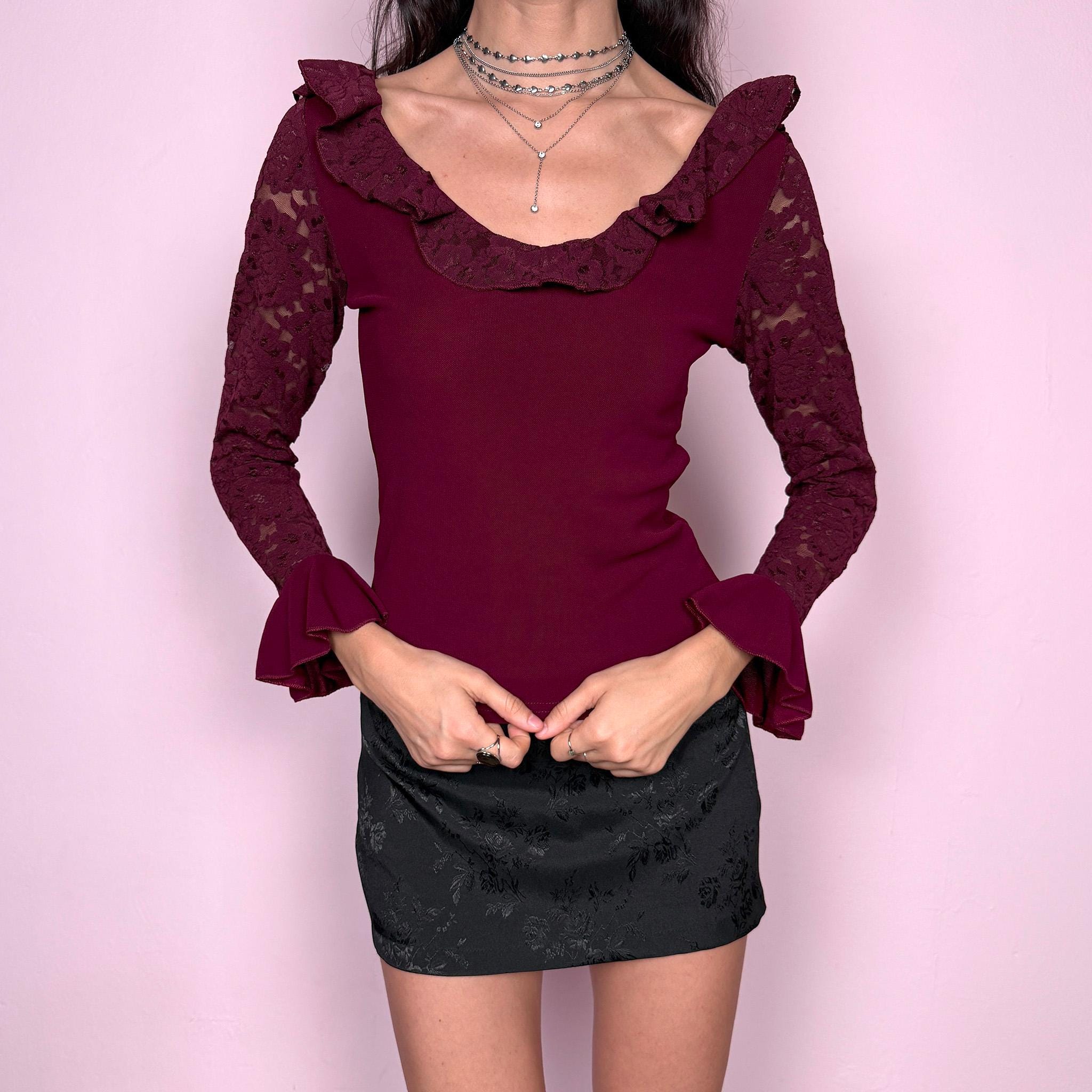 Romantic vintage 2000s burgundy maroon blouse with lace sleeves, ruffled cuffs, and a ruffle lace neckline. Stretchy viscose-nylon-polyamide blend creates a flattering, fitted silhouette. Perfect for coquette, Victorian-inspired evening looks or elegant night styling. Made by a French brand. Excellent vintage condition.