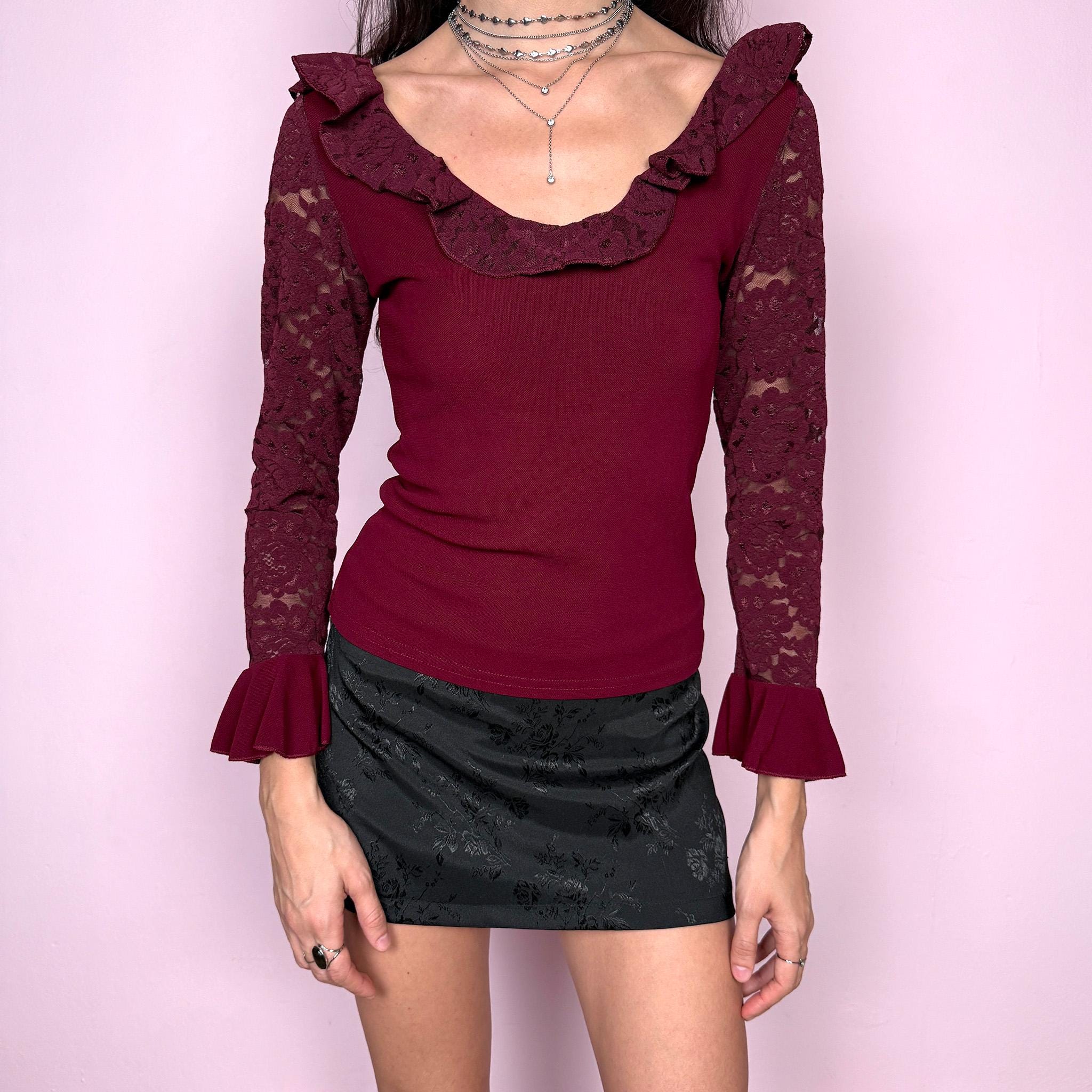 Romantic vintage 2000s burgundy maroon blouse with lace sleeves, ruffled cuffs, and a ruffle lace neckline. Stretchy viscose-nylon-polyamide blend creates a flattering, fitted silhouette. Perfect for coquette, Victorian-inspired evening looks or elegant night styling. Made by a French brand. Excellent vintage condition.