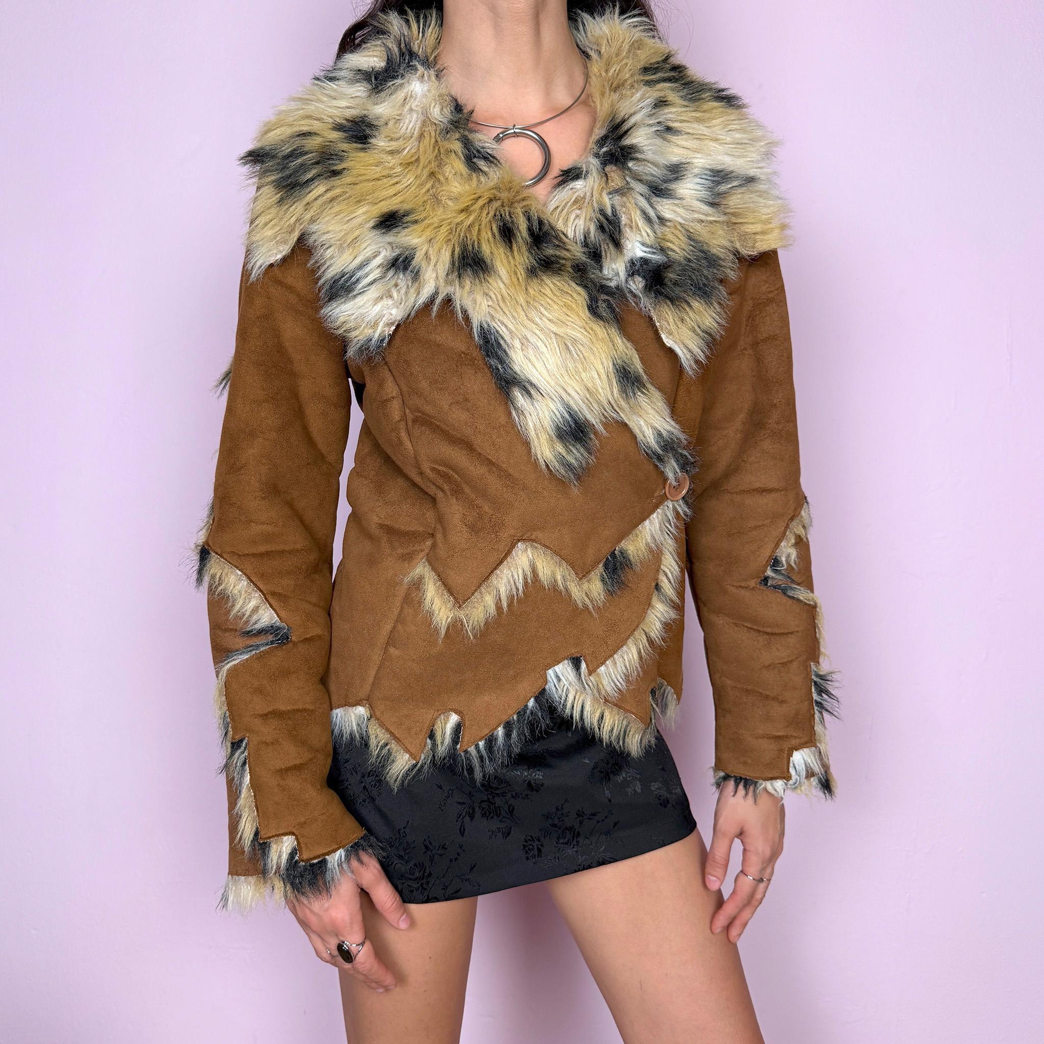 Bold statement vintage 2000s Penny Lane jacket with a brown faux suede exterior and beige and black faux fur interior and collar with an animal print–inspired look. Eye-catching unique design with a fitted silhouette, two-button closure, pockets, and an asymmetric hem. Made from polyester by a European brand. Excellent vintage condition.