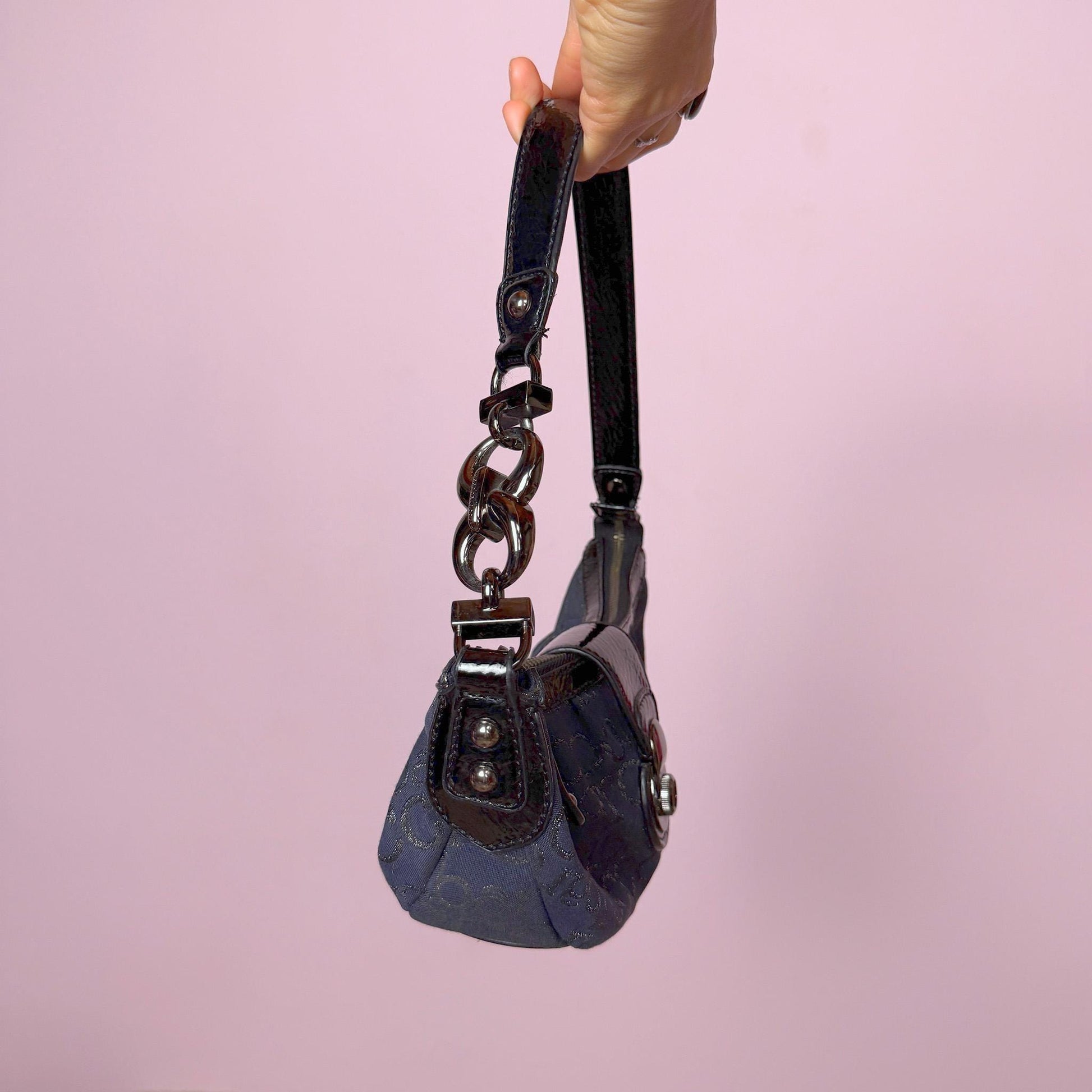 Iconic vintage early 2000s navy blue mini baguette bag by Roccobarocco. Features signature monogram canvas with glossy black patent details, sculptural hardware, zip closure, and push-down turn-lock closure. A quintessential Italian going-out accessory with a bold Y2K silhouette. Made in Italy. Great vintage condition.
