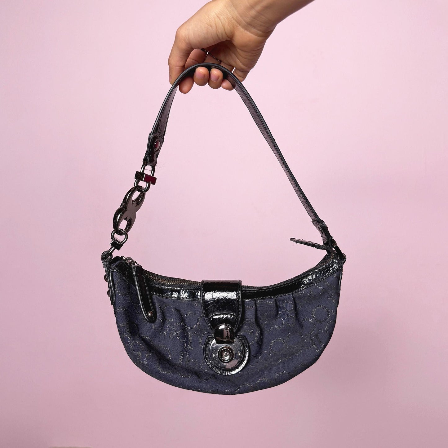 Iconic vintage early 2000s navy blue mini baguette bag by Roccobarocco. Features signature monogram canvas with glossy black patent details, sculptural hardware, zip closure, and push-down turn-lock closure. A quintessential Italian going-out accessory with a bold Y2K silhouette. Made in Italy. Great vintage condition.