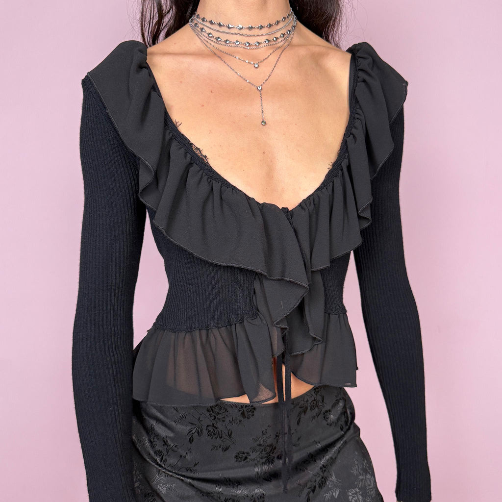 Dark romance vintage 2000s black ribbed knit long sleeve tie-front cropped cardigan with ruffle neckline and hem. Feminine coquette goth bolero style layering jacket with a stretchy fit. Made in Italy by an Italian brand from Polyamide, Polyester, and Viscose. Excellent vintage condition.