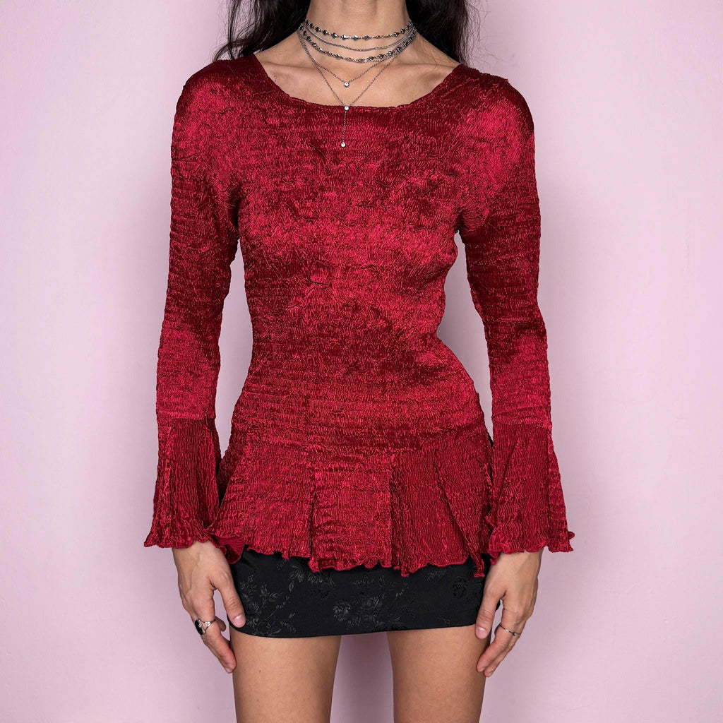Stunning vintage 2000s burgundy maroon crinkle-pleated blouse featuring dramatic asymmetric bell sleeves, a fitted silhouette, and an asymmetric flared hem. Romantic and avant-garde, ideal for formal parties, festivals, or bold evening wear. Rare archival French design made from polyester by a French brand. Excellent vintage condition.