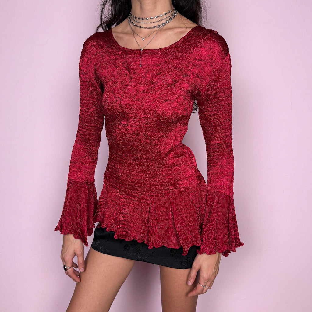 Stunning vintage 2000s burgundy maroon crinkle-pleated blouse featuring dramatic asymmetric bell sleeves, a fitted silhouette, and an asymmetric flared hem. Romantic and avant-garde, ideal for formal parties, festivals, or bold evening wear. Rare archival French design made from polyester by a French brand. Excellent vintage condition.