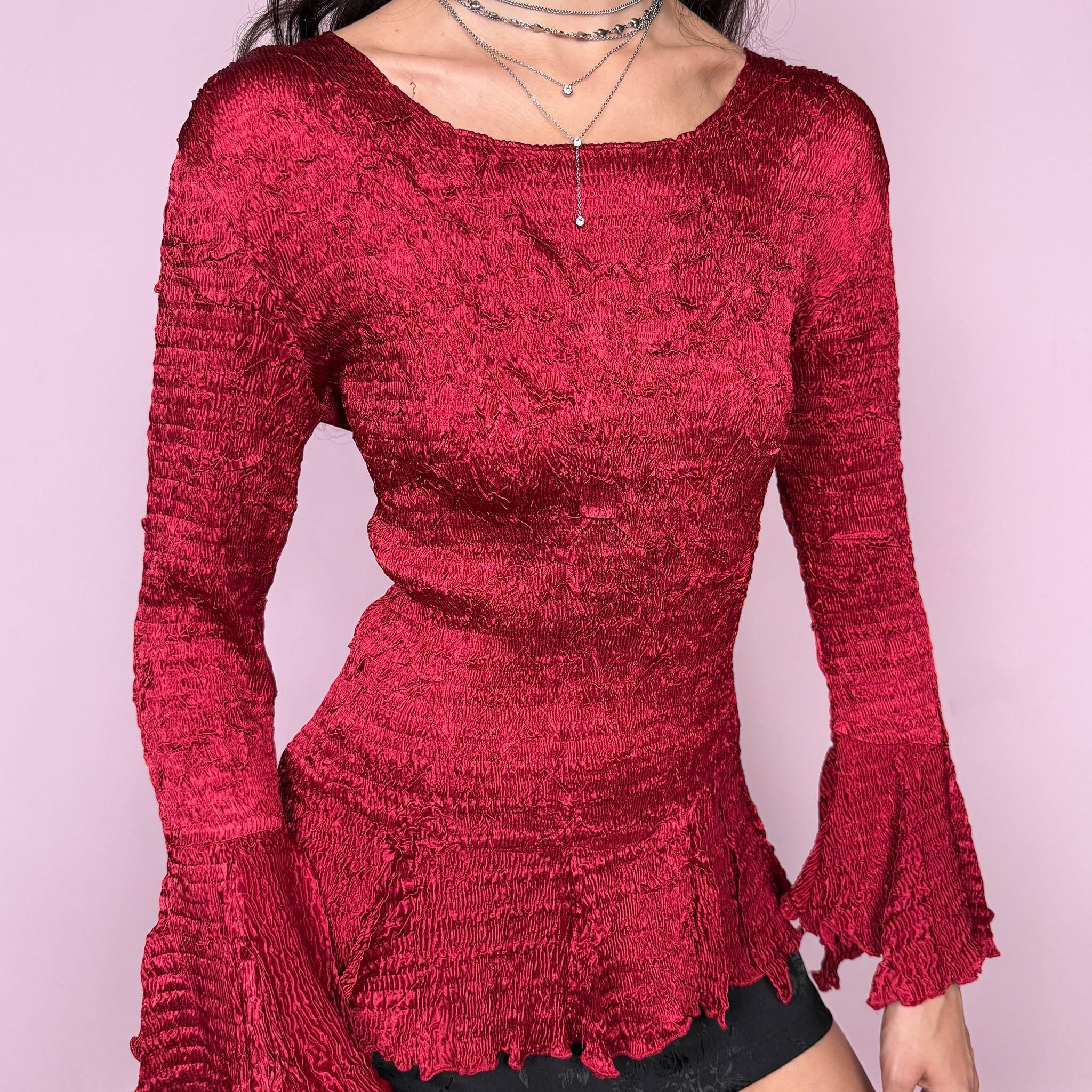 Stunning vintage 2000s burgundy maroon crinkle-pleated blouse featuring dramatic asymmetric bell sleeves, a fitted silhouette, and an asymmetric flared hem. Romantic and avant-garde, ideal for formal parties, festivals, or bold evening wear. Rare archival French design made from polyester by a French brand. Excellent vintage condition.