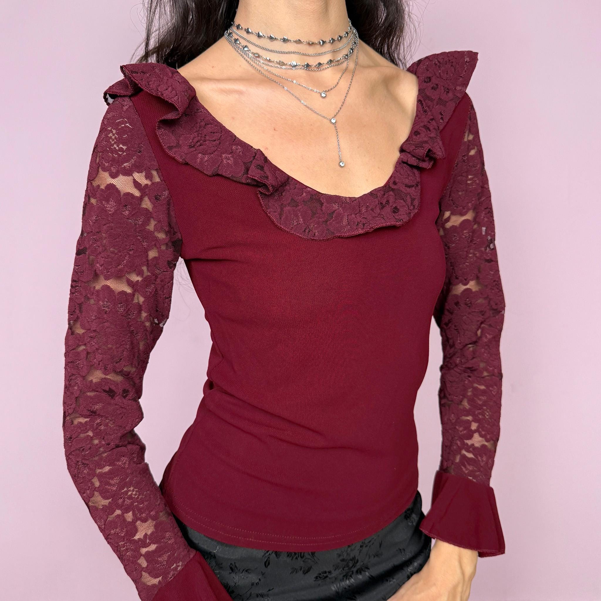 Romantic vintage 2000s burgundy maroon blouse with lace sleeves, ruffled cuffs, and a ruffle lace neckline. Stretchy viscose-nylon-polyamide blend creates a flattering, fitted silhouette. Perfect for coquette, Victorian-inspired evening looks or elegant night styling. Made by a French brand. Excellent vintage condition.