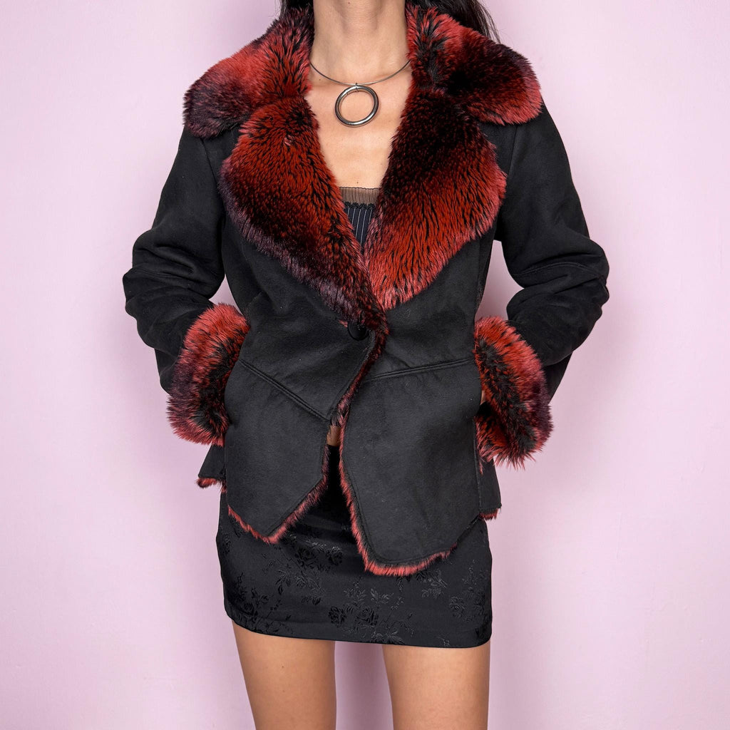 Stunning vintage 2000s Penny Lane–inspired jacket featuring a black faux suede exterior with bold red and black faux fur collar and cuffs. Designed with a fitted cut, single button closure, and front pockets. A statement piece made from polyester by a French brand. Excellent vintage condition.
