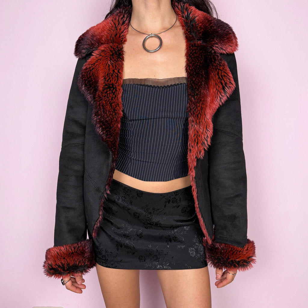 Stunning vintage 2000s Penny Lane–inspired jacket featuring a black faux suede exterior with bold red and black faux fur collar and cuffs. Designed with a fitted cut, single button closure, and front pockets. A statement piece made from polyester by a French brand. Excellent vintage condition.