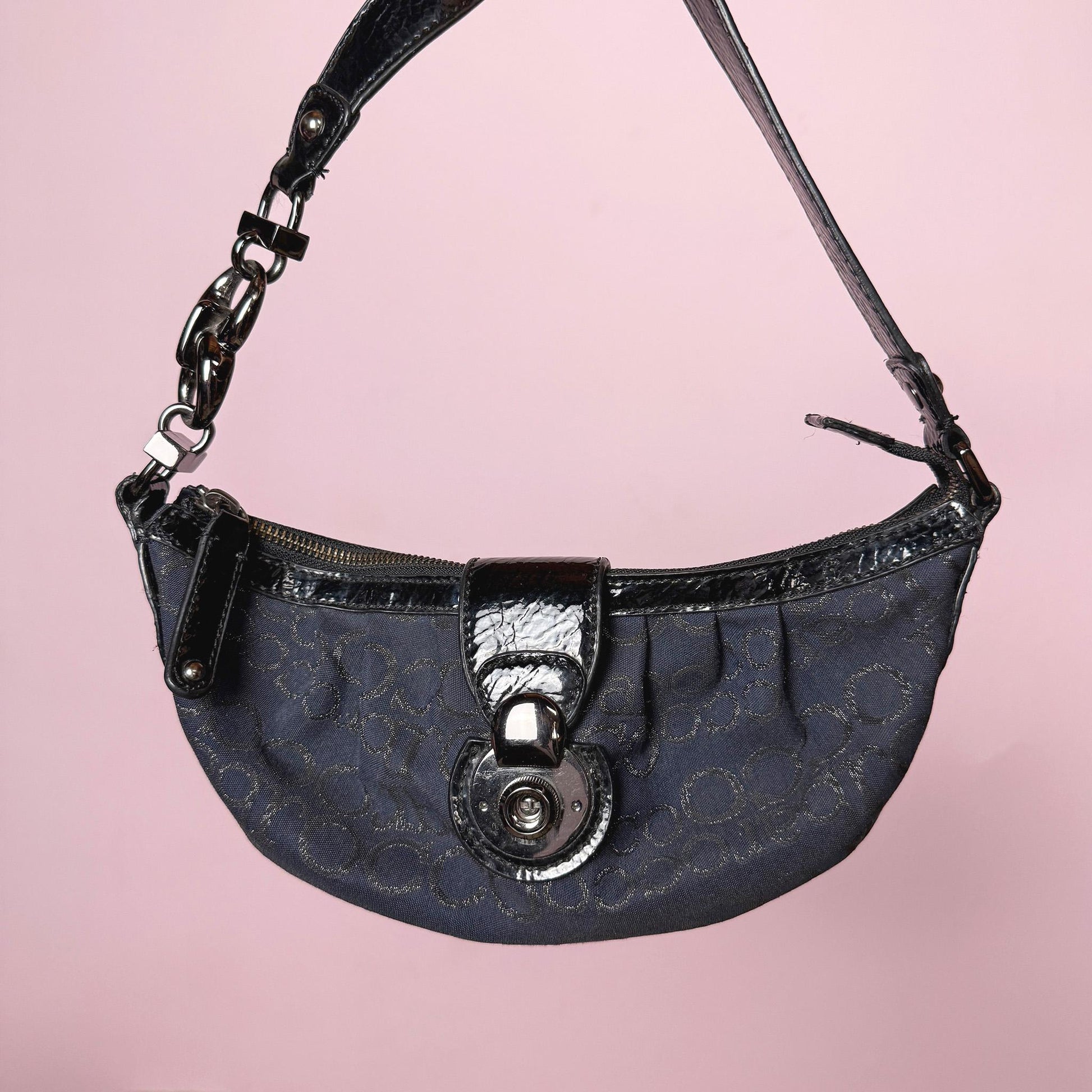 Iconic vintage early 2000s navy blue mini baguette bag by Roccobarocco. Features signature monogram canvas with glossy black patent details, sculptural hardware, zip closure, and push-down turn-lock closure. A quintessential Italian going-out accessory with a bold Y2K silhouette. Made in Italy. Great vintage condition.