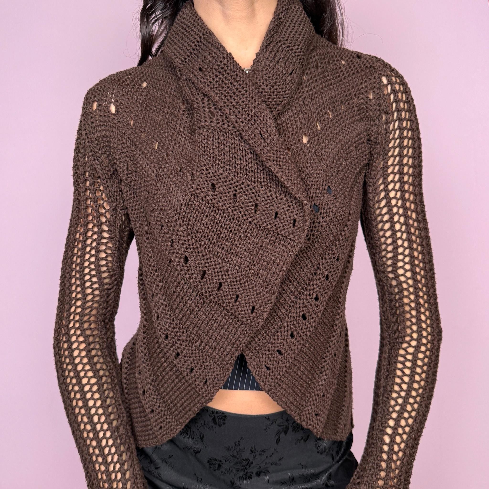 Boho fairycore vintage 2000s dark brown open knit cardigan with a sheer finish and long bell sleeves. Features a folded draped neckline and open front with no closure. Lightweight and stretchy, designed for avant garde autumn or spring layering. Can be worn multiple ways and styled with a safety pin or brooch for a custom fit. Great vintage condition.