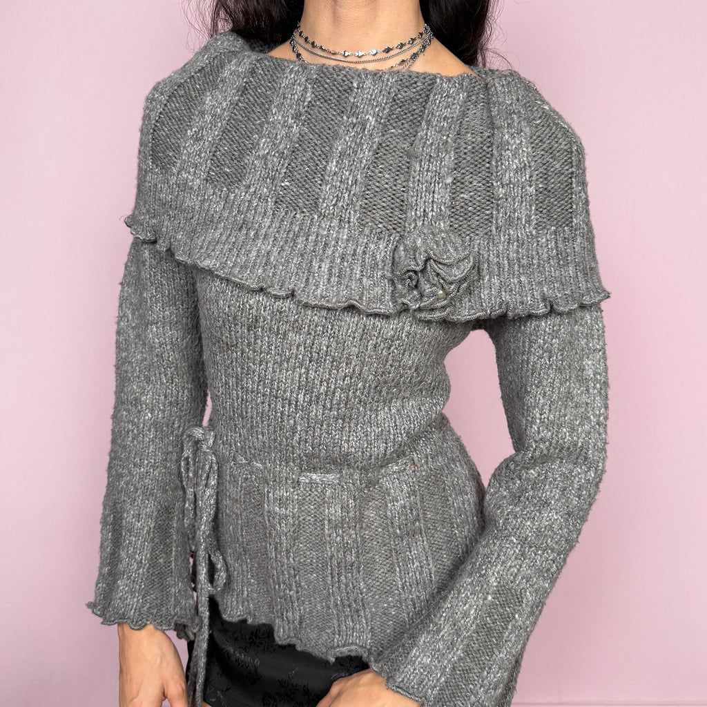 Romantic coquette vintage 2000s gray knit sweater with a folded collar and delicate rosette applique detail. Features flared long sleeves, a tie waist for a cinched silhouette, and a soft stretchy feel. Feminine and cozy, ideal for winter layering or dressed-up Y2K styling. Made from 50% mohair, 40% wool, and 10% spandex. Great vintage condition.